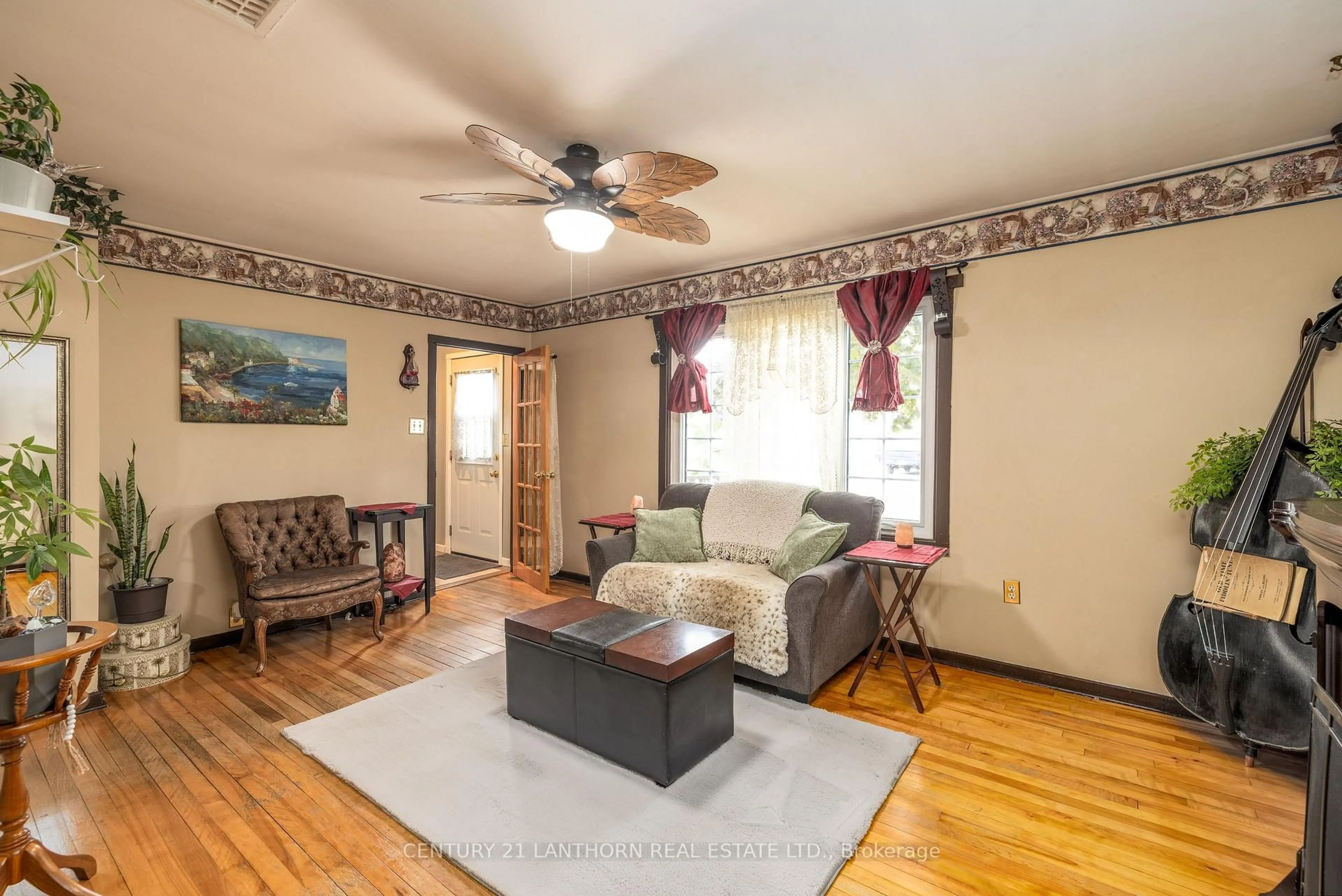 Living room with furniture, wood/laminate floor for 8 Johnson Rd, Quinte West Ontario K8V 2W7