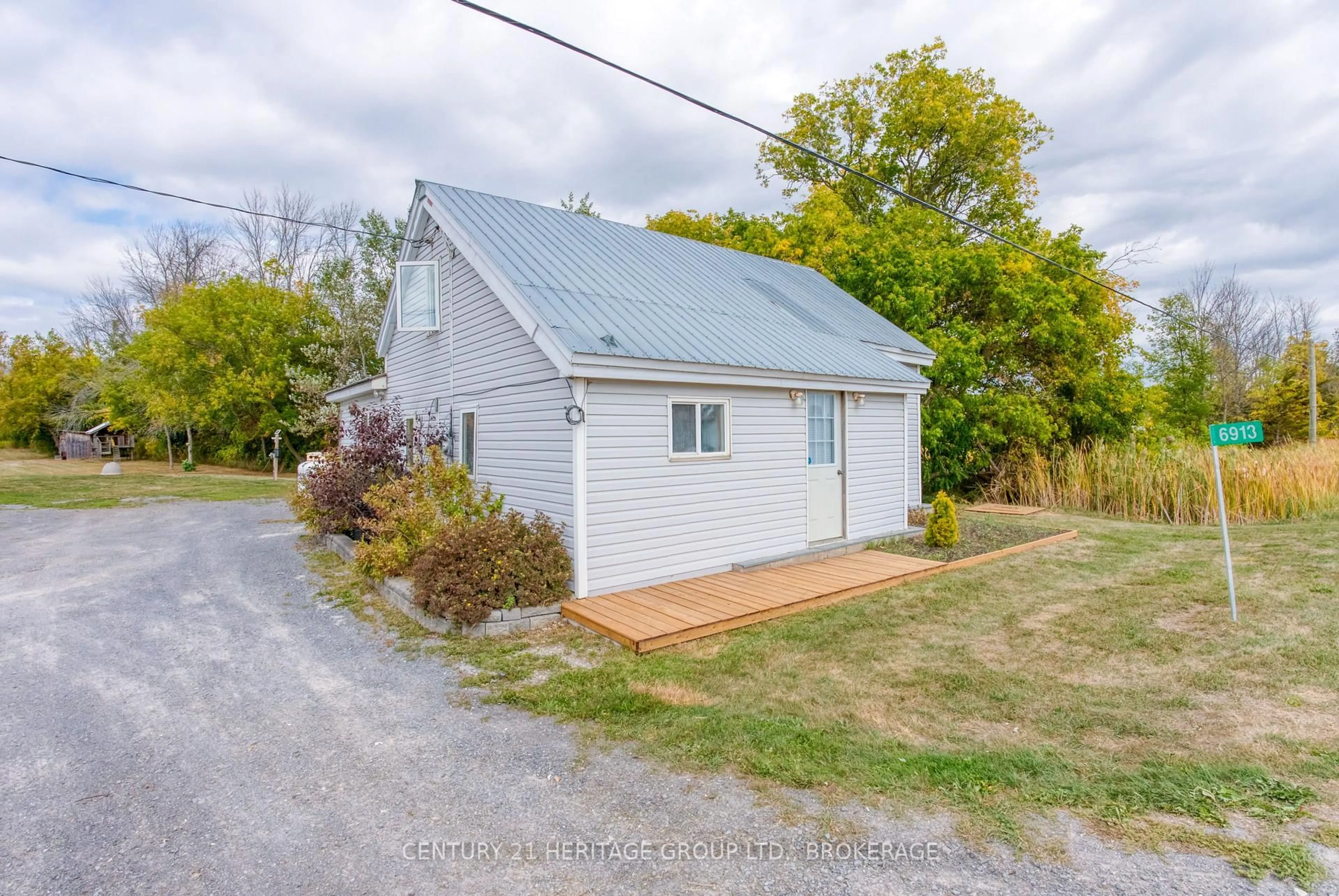 A pic from outside/outdoor area/front of a property/back of a property/a pic from drone, street for 6913 County 2 Rd, Napanee Ontario K7R 3K6