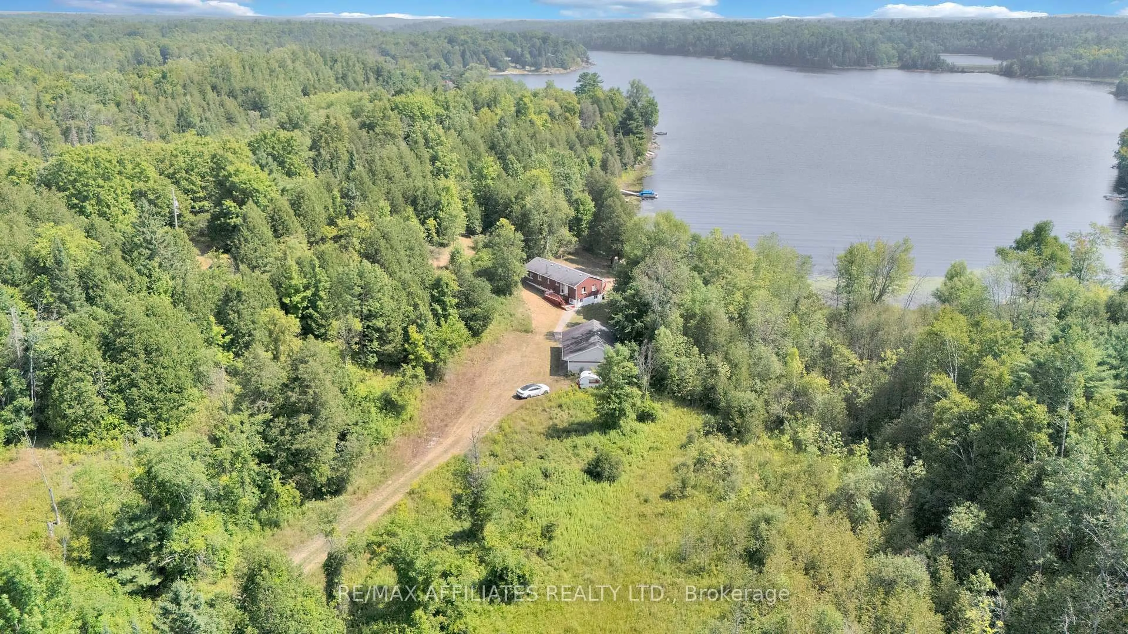 A pic from outside/outdoor area/front of a property/back of a property/a pic from drone, water/lake/river/ocean view for 1009 Gardiner's Rd, Arden Ontario K0H 1B0