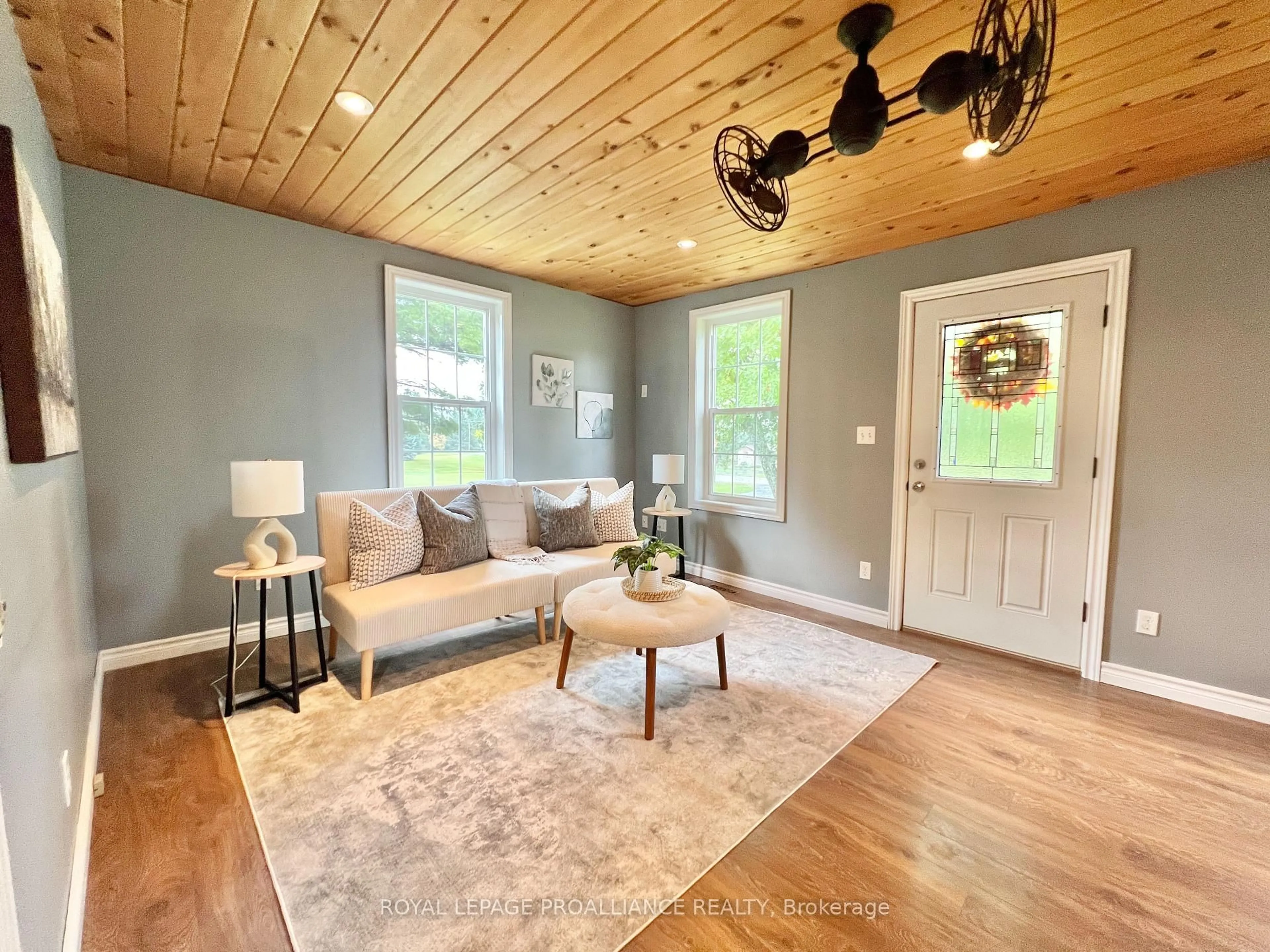 Living room with furniture, wood/laminate floor for 310 Old Madoc Rd, Quinte West Ontario K0K 2B0