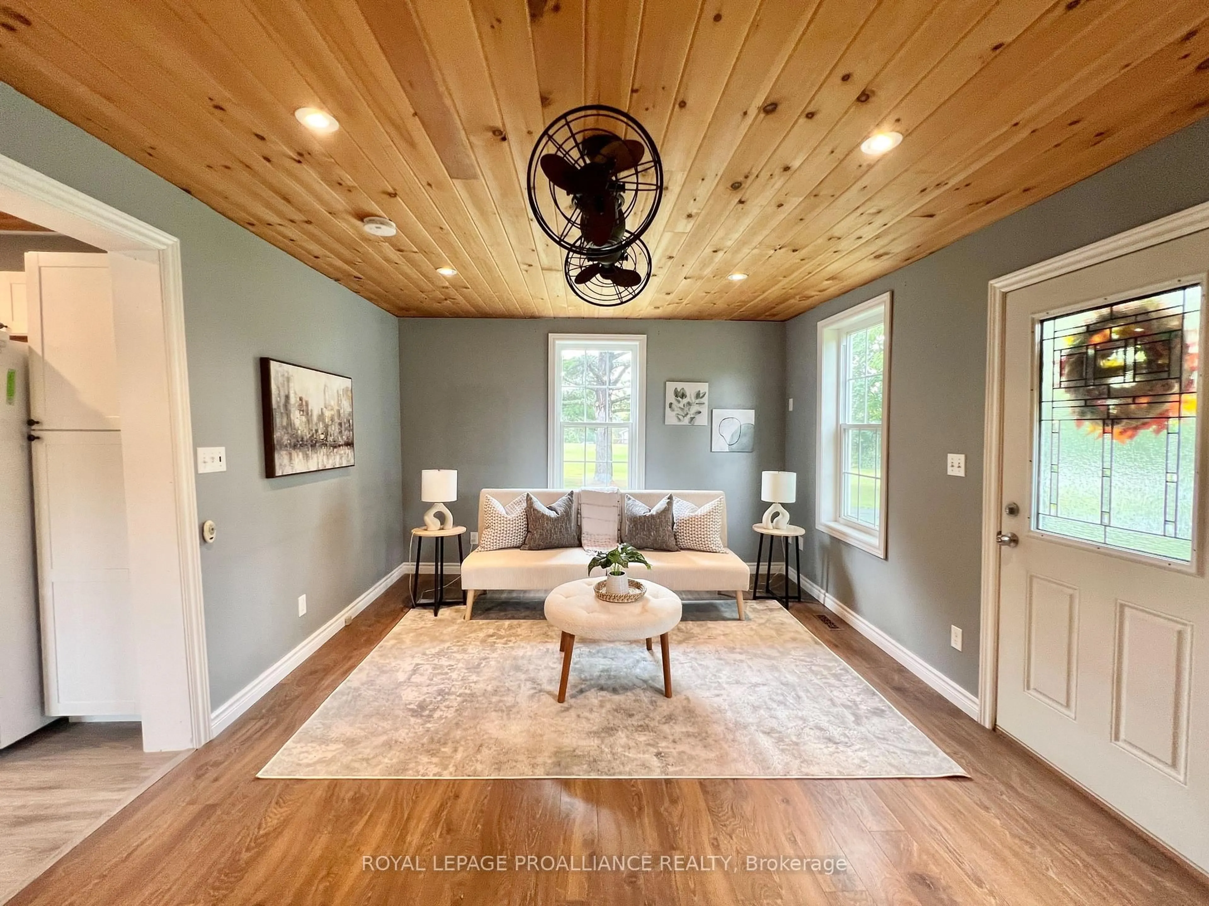 Living room with furniture, wood/laminate floor for 310 Old Madoc Rd, Quinte West Ontario K0K 2B0
