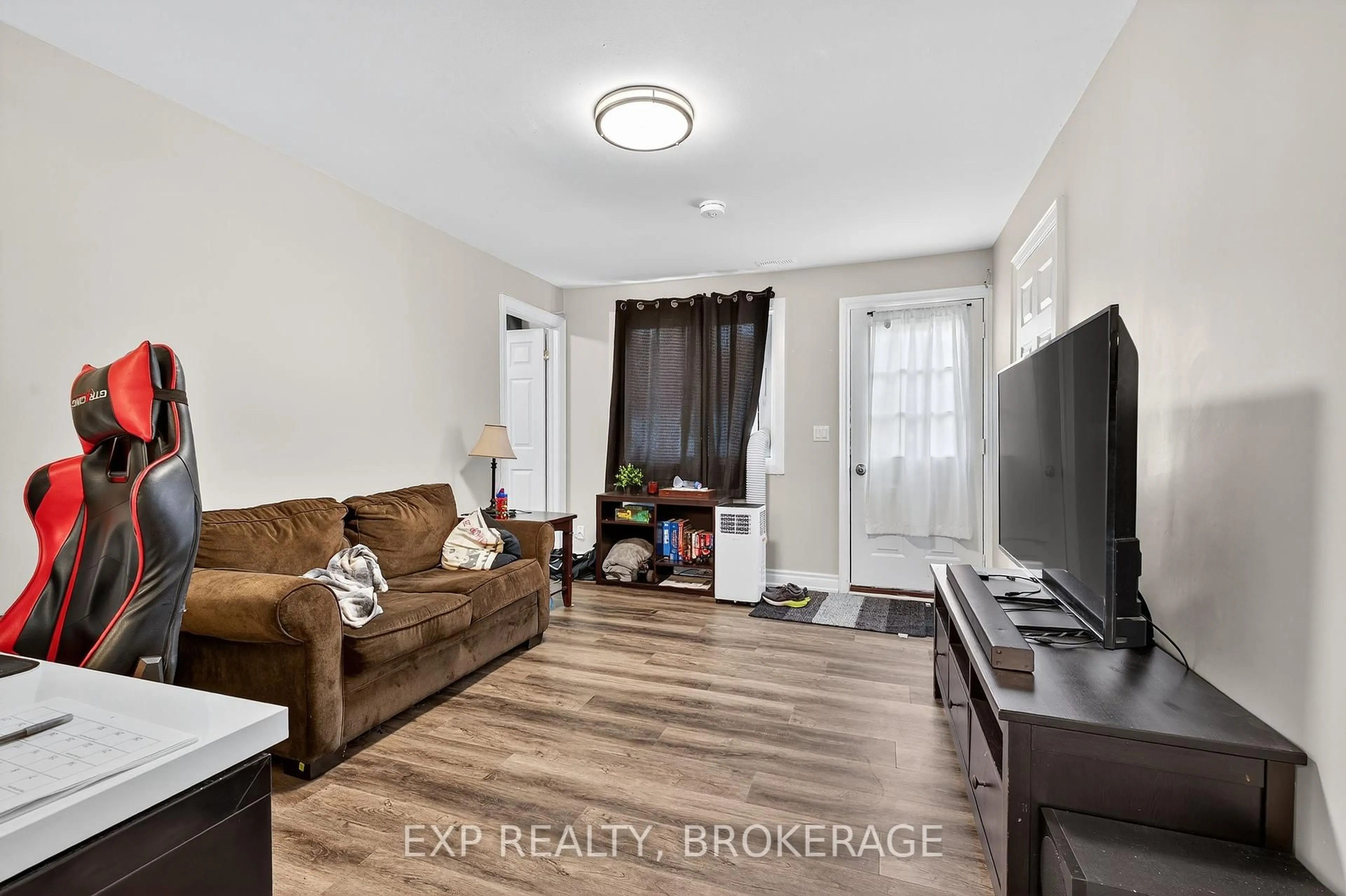Living room with furniture, wood/laminate floor for 225-227 VICTORIA Ave, Gananoque Ontario K7G 2S3