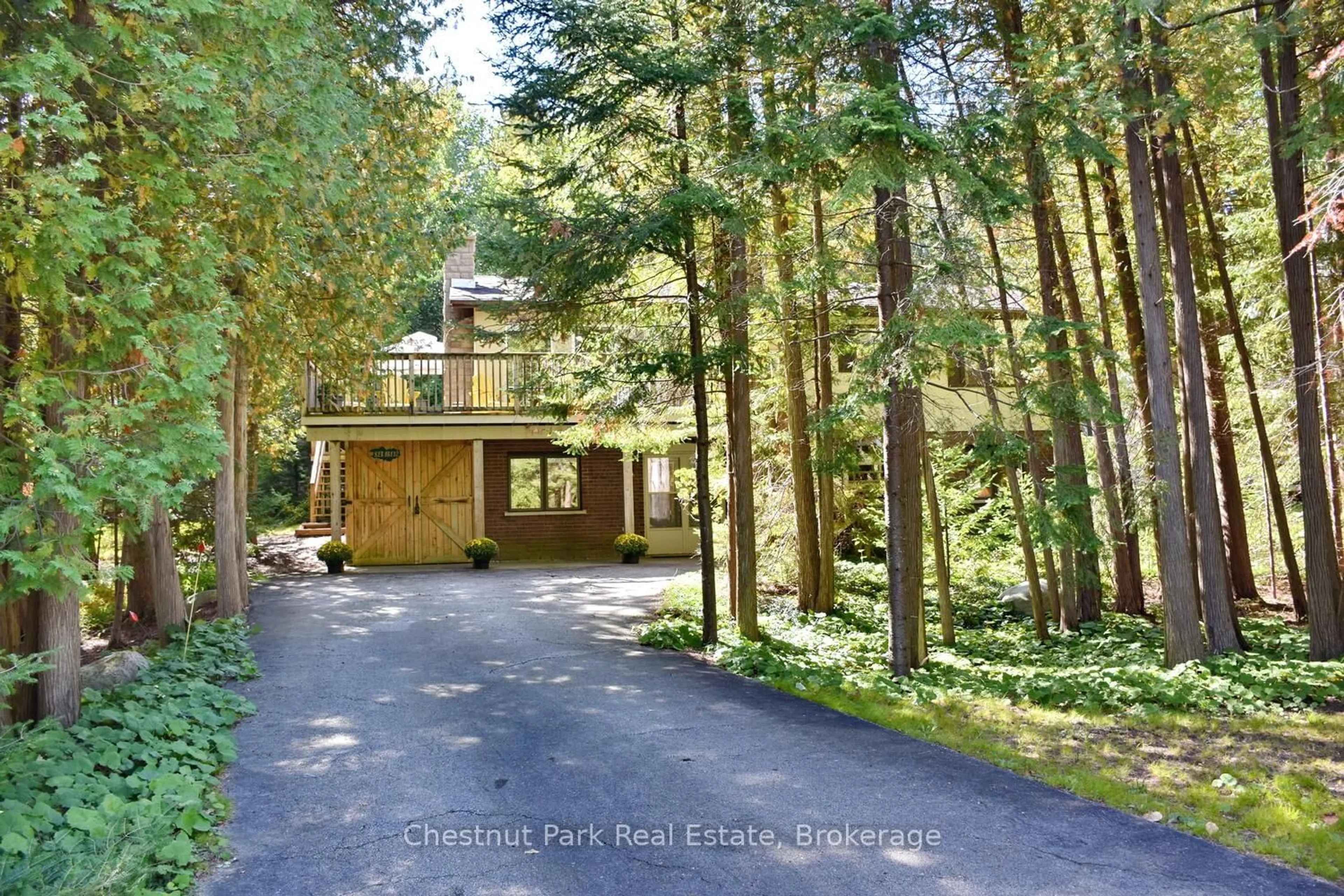 A pic from outside/outdoor area/front of a property/back of a property/a pic from drone, forest/trees view for 128 Lakewood Dr, Blue Mountains Ontario N0H 1J0