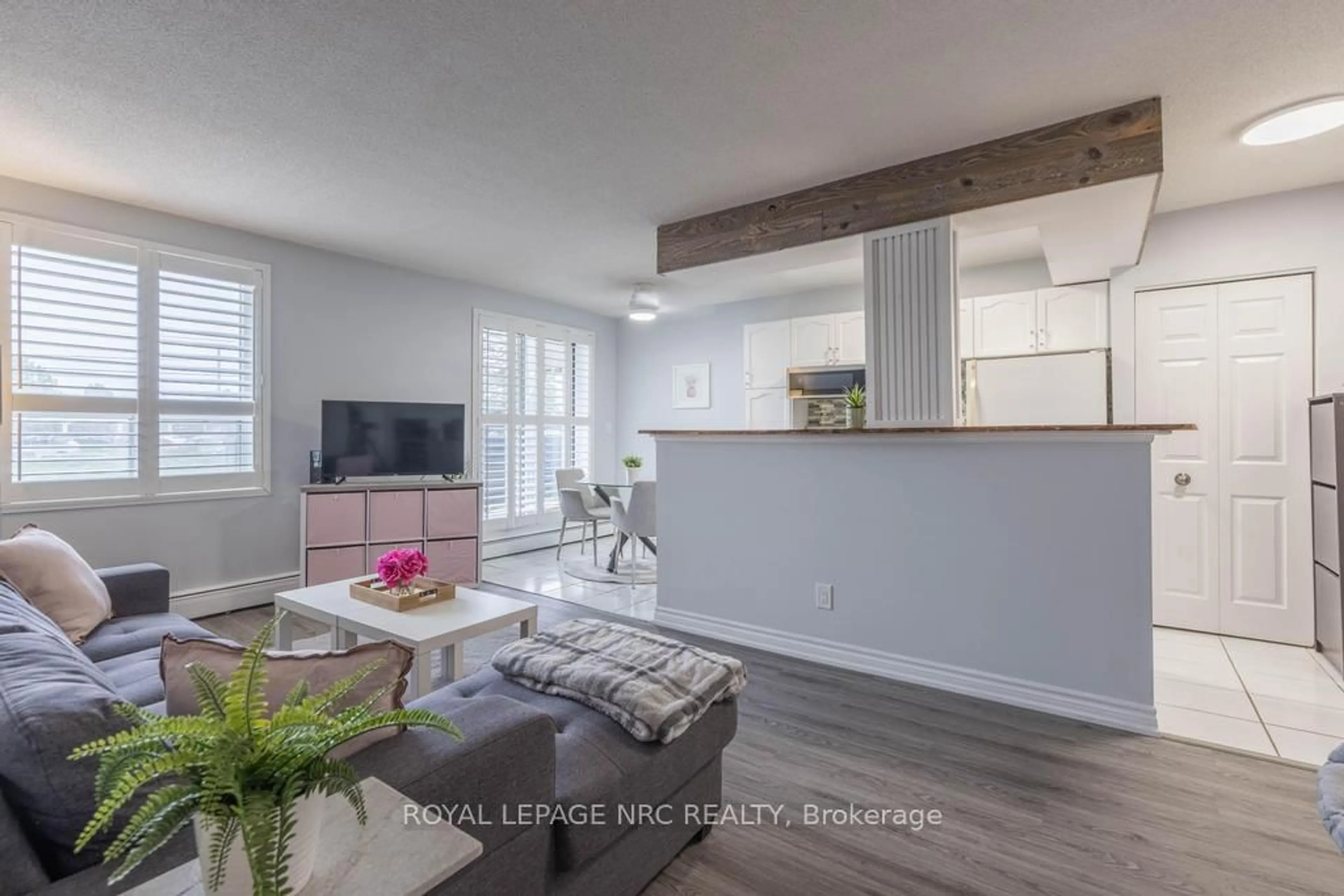 Living room with furniture, wood/laminate floor for 851 Queenston Rd #104, Hamilton Ontario L8G 1B4