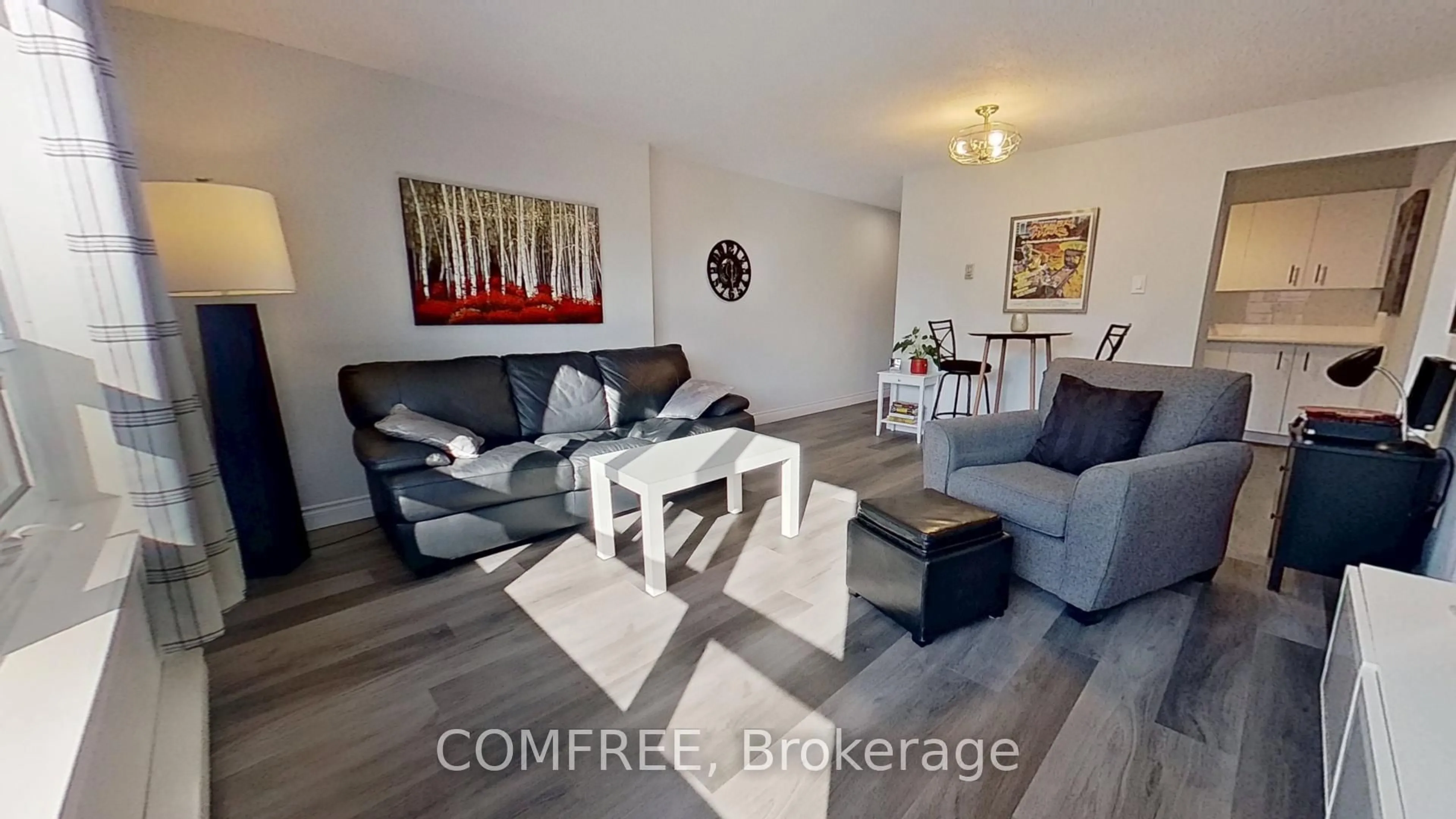 Living room with furniture, wood/laminate floor for 95 Baseline Rd #8, London South Ontario N6J 4X3