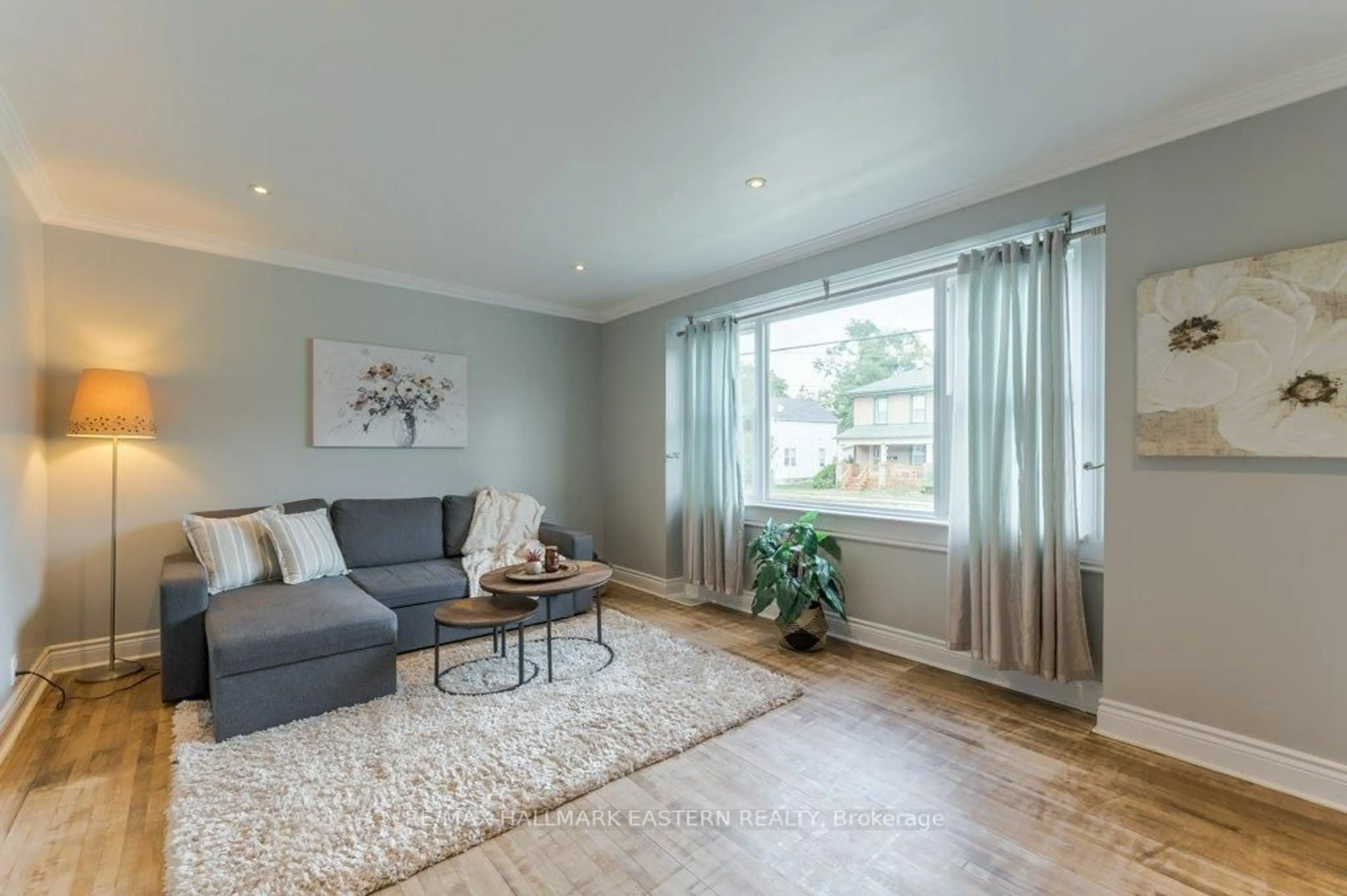 Living room with furniture, wood/laminate floor for 677 Armour Rd, Peterborough Ontario K9H 1Z5