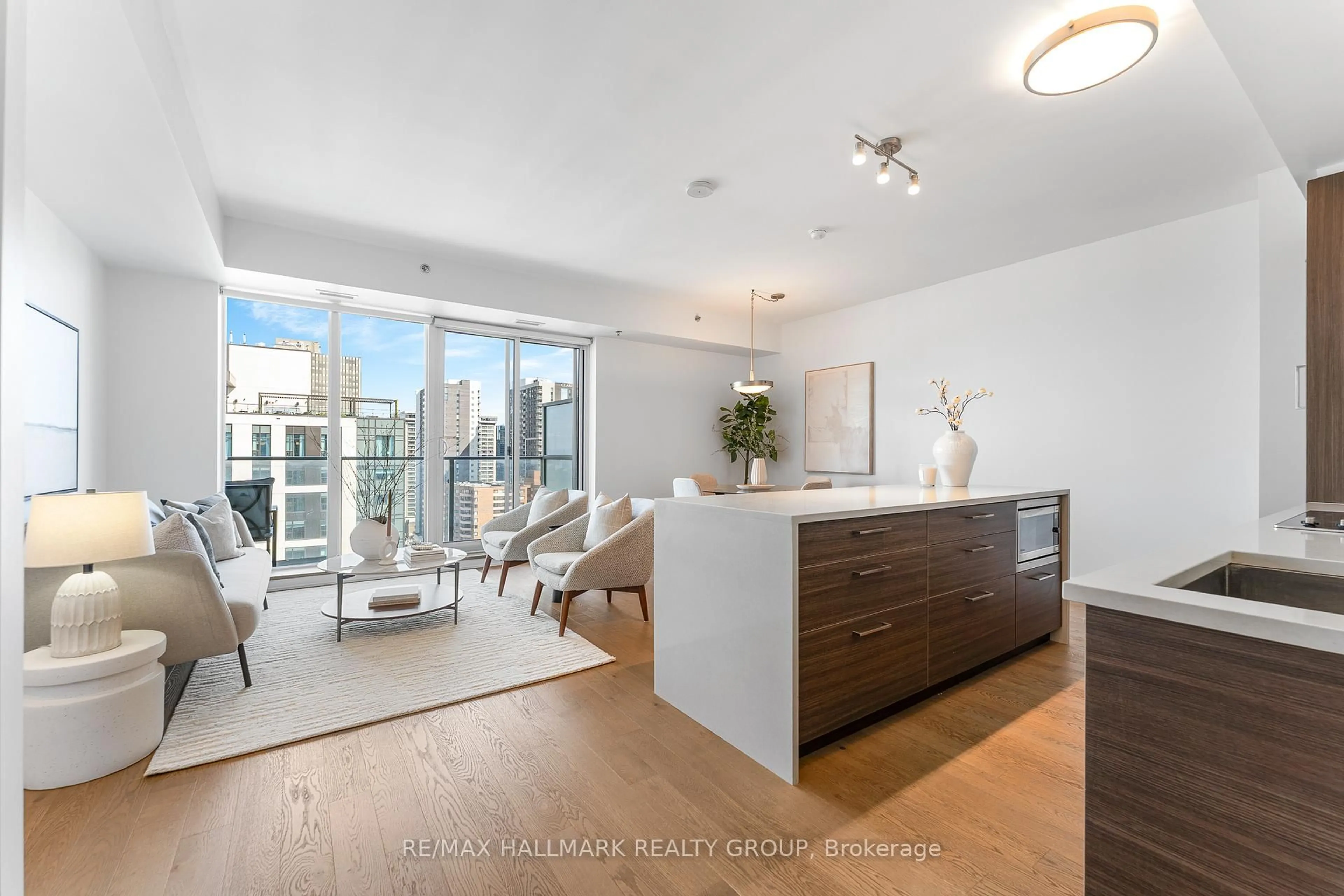 Living room with furniture, wood/laminate floor for 428 Sparks St #1807, Ottawa Ontario K1R 0B3