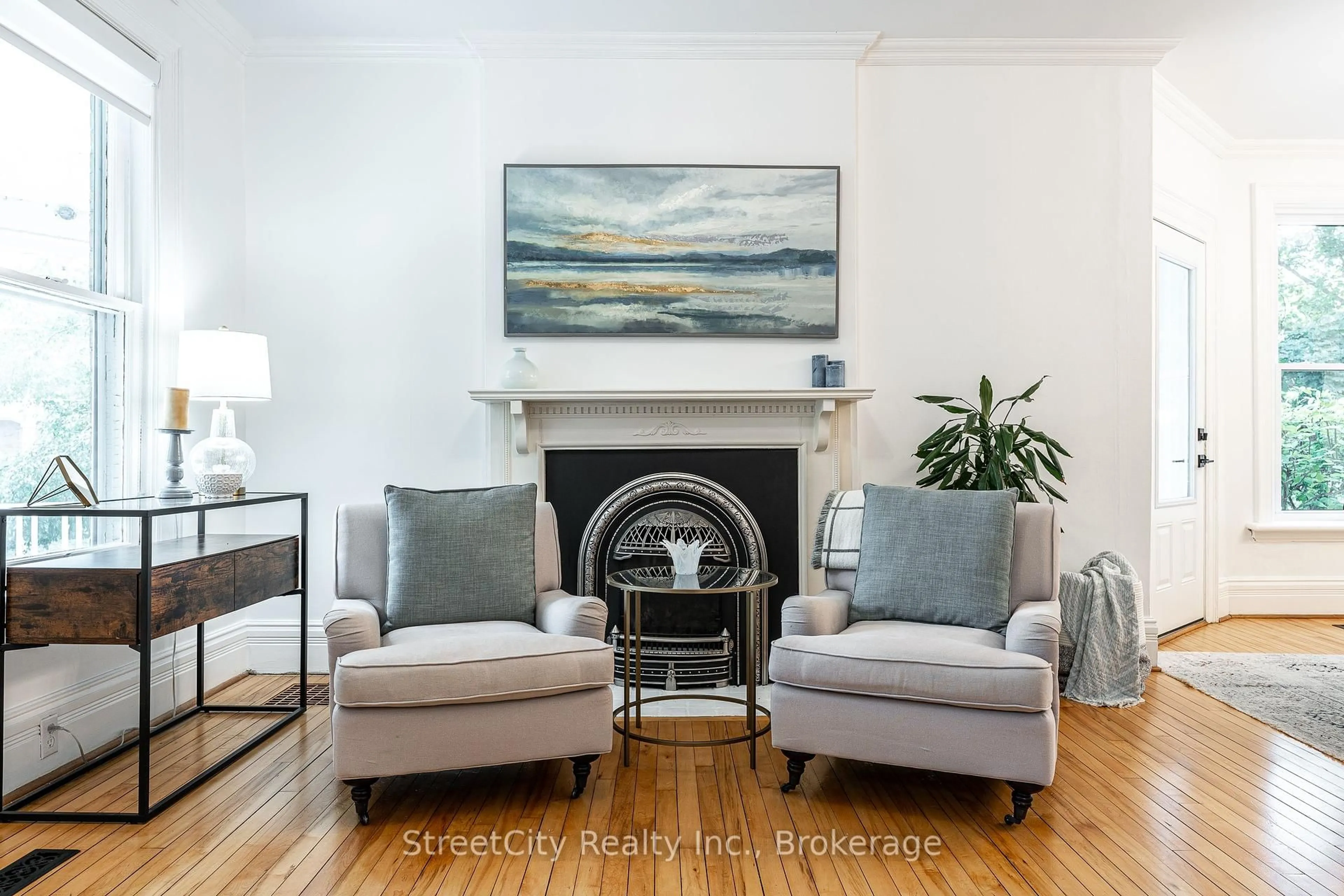 Living room with furniture, wood/laminate floor for 18 Waterloo St, Stratford Ontario N5A 5H5