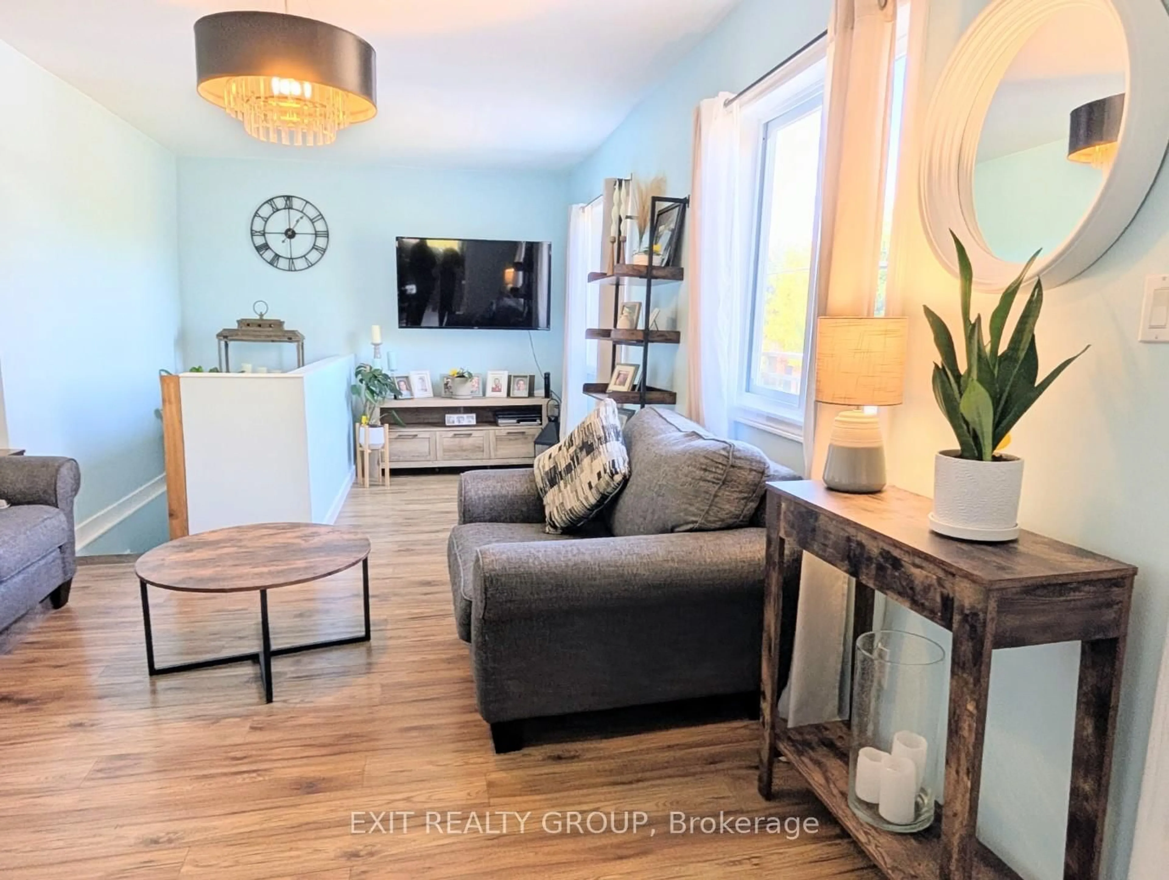 Living room with furniture, wood/laminate floor for 12075 Loyalist Pkwy, Prince Edward County Ontario K0K 2T0