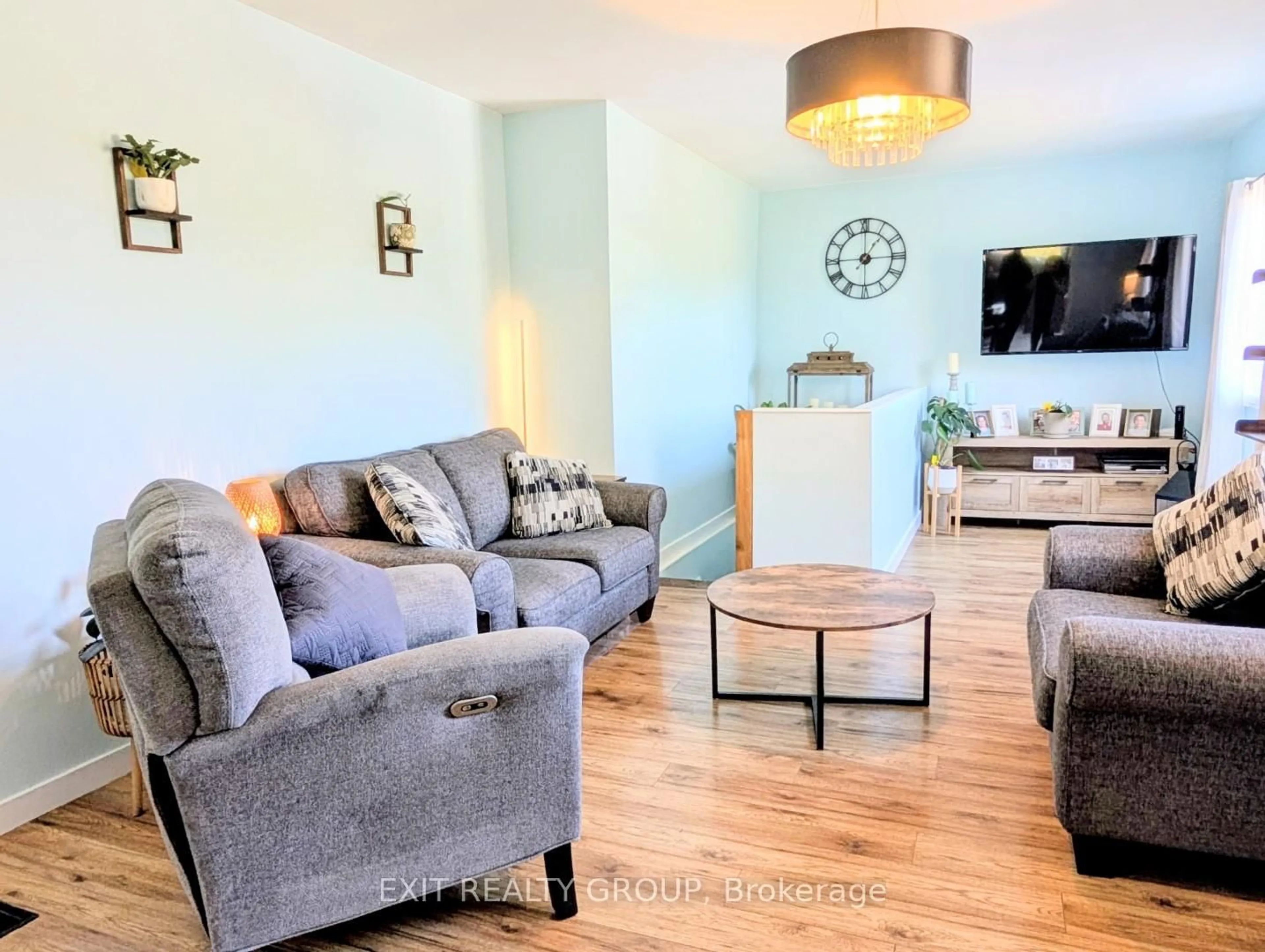 Living room with furniture, wood/laminate floor for 12075 Loyalist Pkwy, Prince Edward County Ontario K0K 2T0