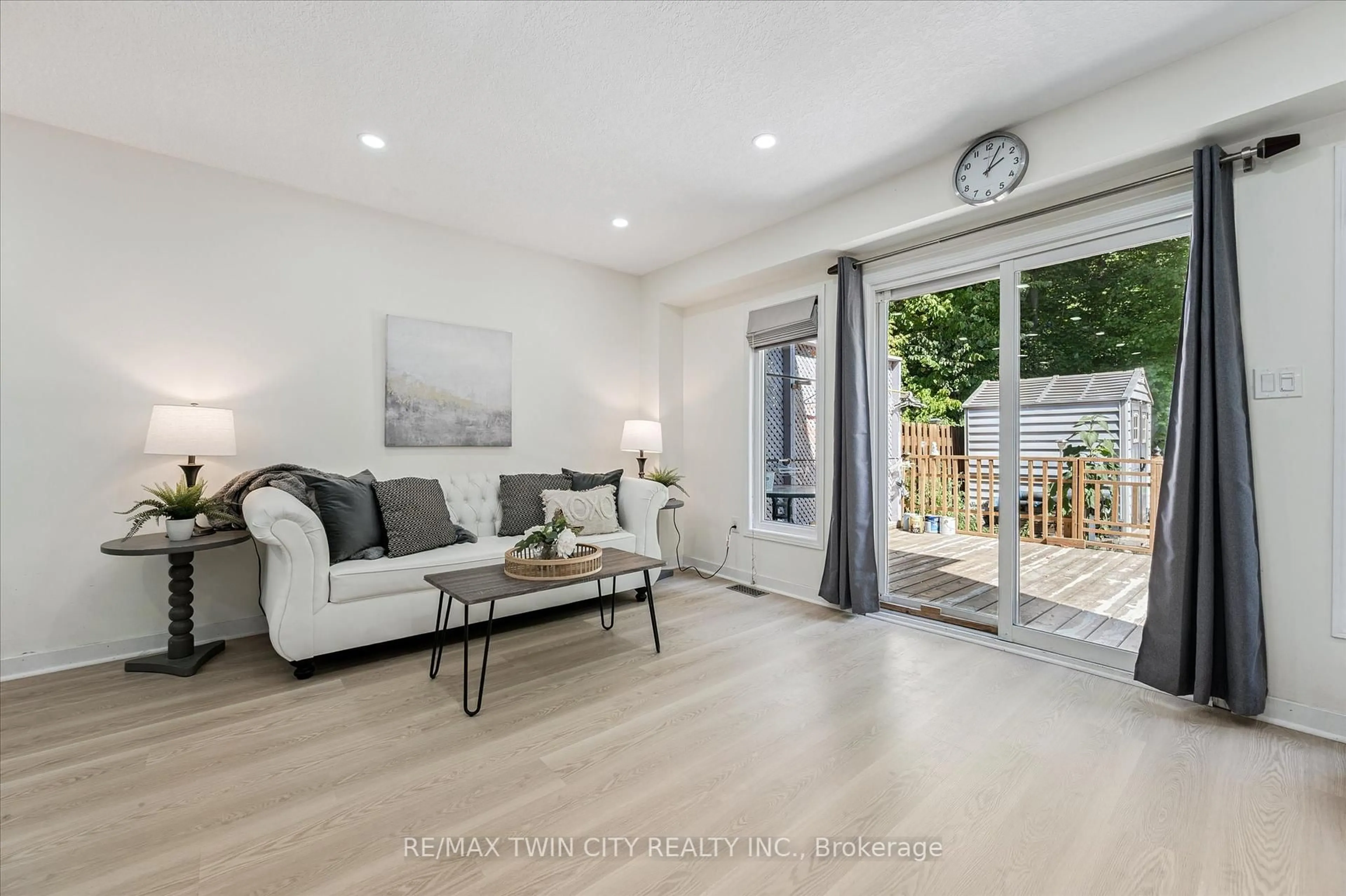 Living room with furniture, wood/laminate floor for 110 Activa Ave #E29, Kitchener Ontario N2E 3T3