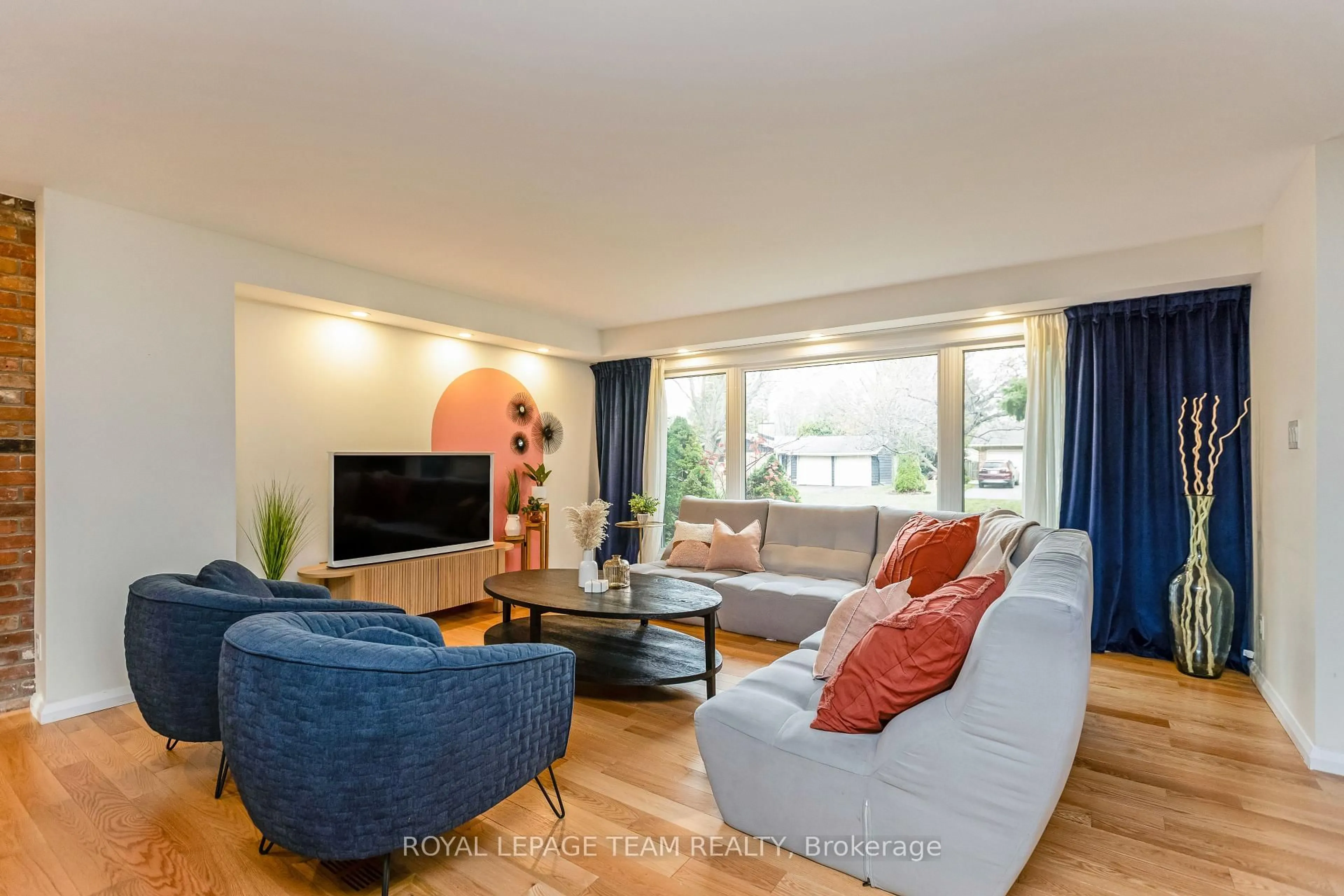 Living room with furniture, wood/laminate floor for 12 Pellan Cres, Ottawa Ontario K2K 1J5