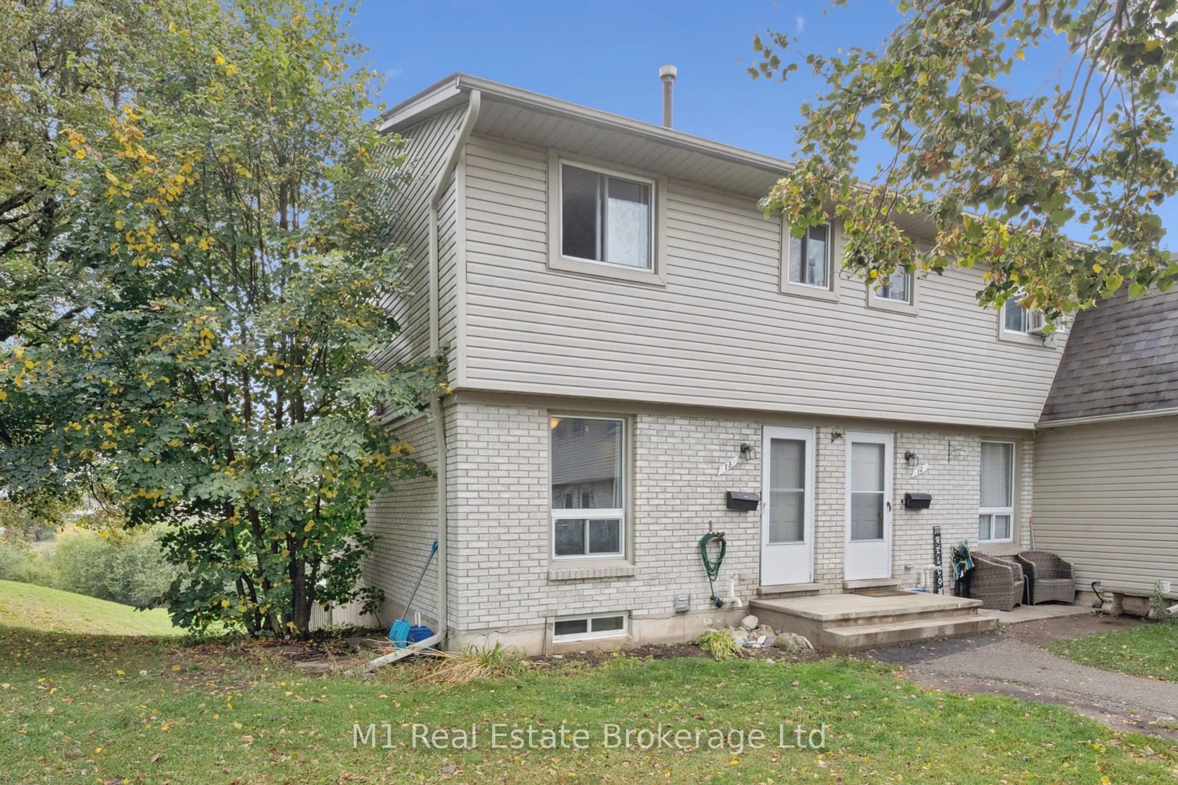 Home with vinyl exterior material, street for 700 Paisley Rd #13, Guelph Ontario N1K 1A3