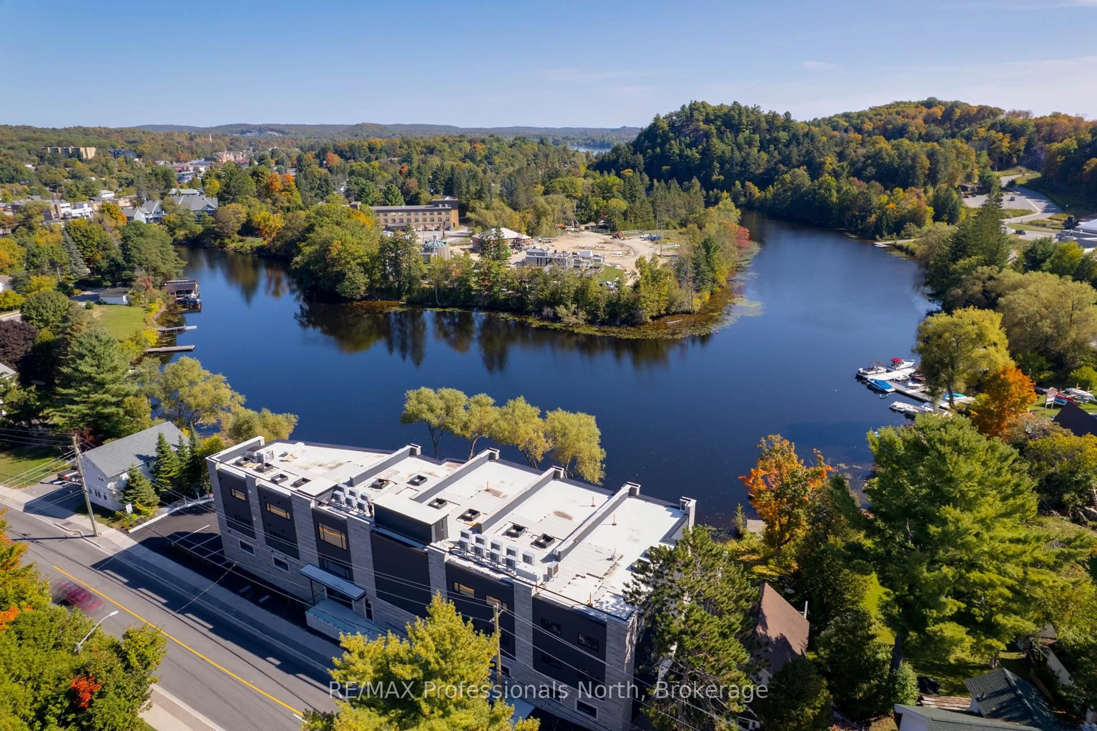 A pic from outside/outdoor area/front of a property/back of a property/a pic from drone, water/lake/river/ocean view for 32 Brunel Rd #201, Huntsville Ontario P1H 1P5
