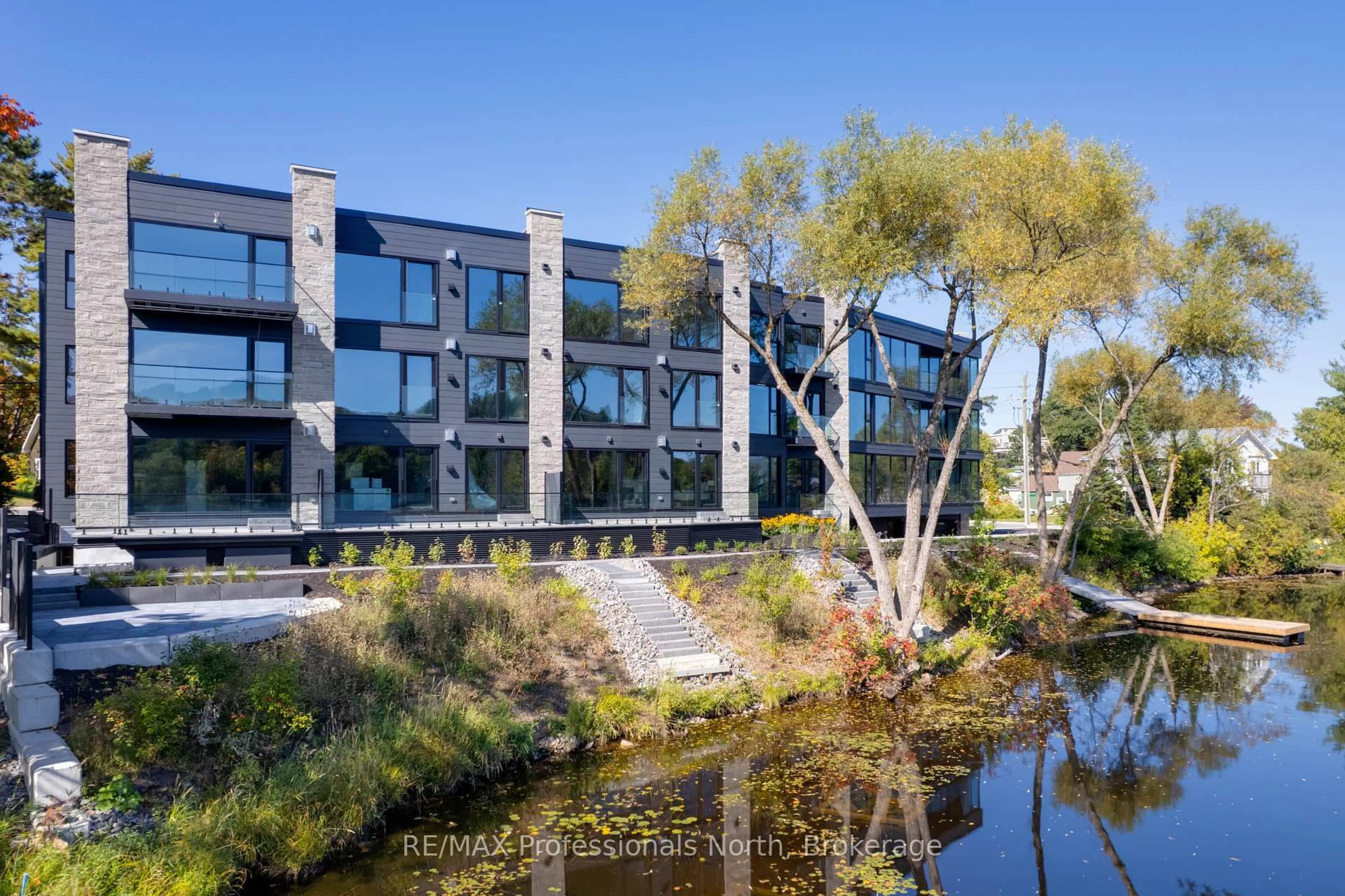 A pic from outside/outdoor area/front of a property/back of a property/a pic from drone, water/lake/river/ocean view for 32 Brunel Rd #201, Huntsville Ontario P1H 1P5