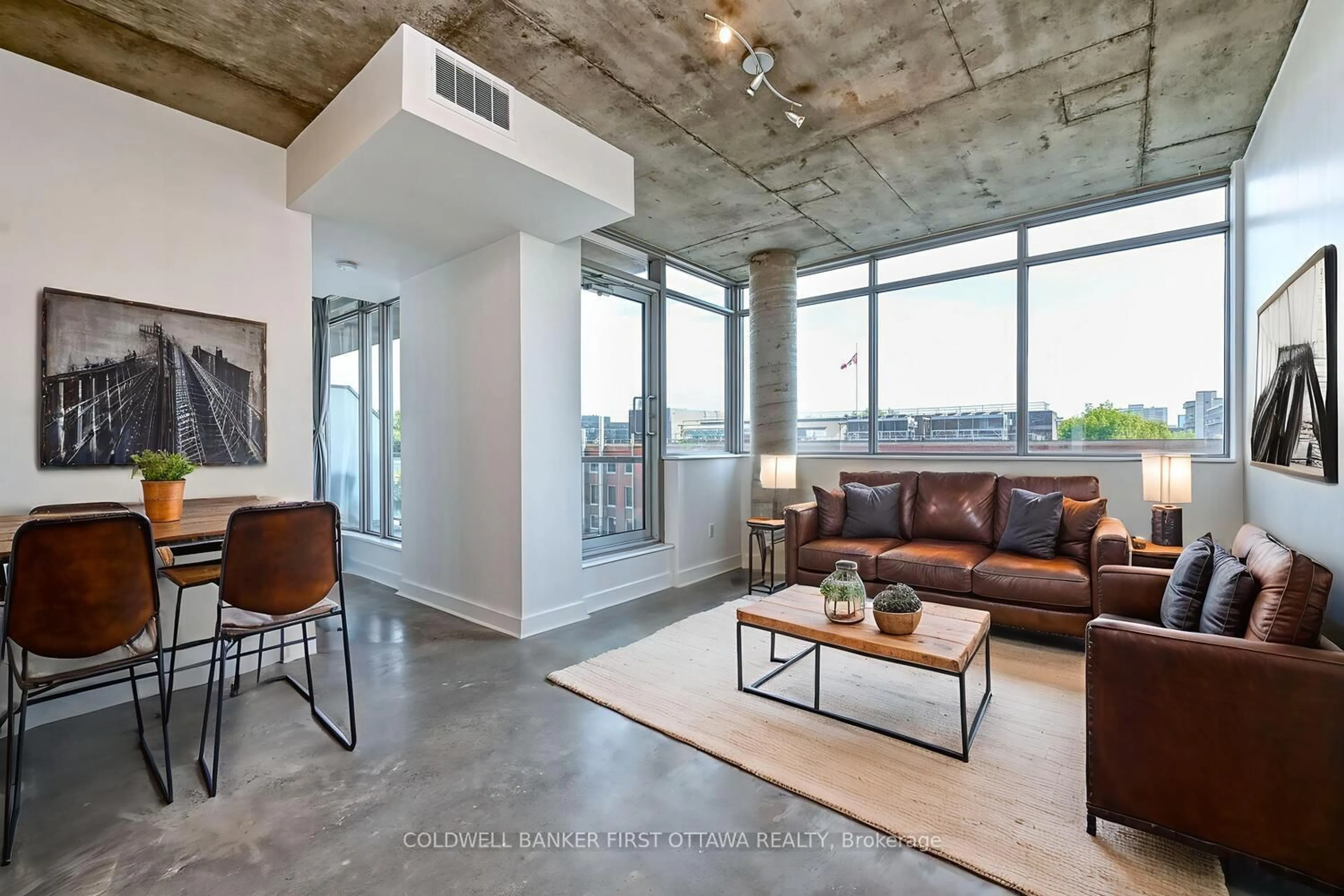 Living room with furniture, cement floor for 383 Cumberland St #506, Ottawa Ontario K1N 1J7