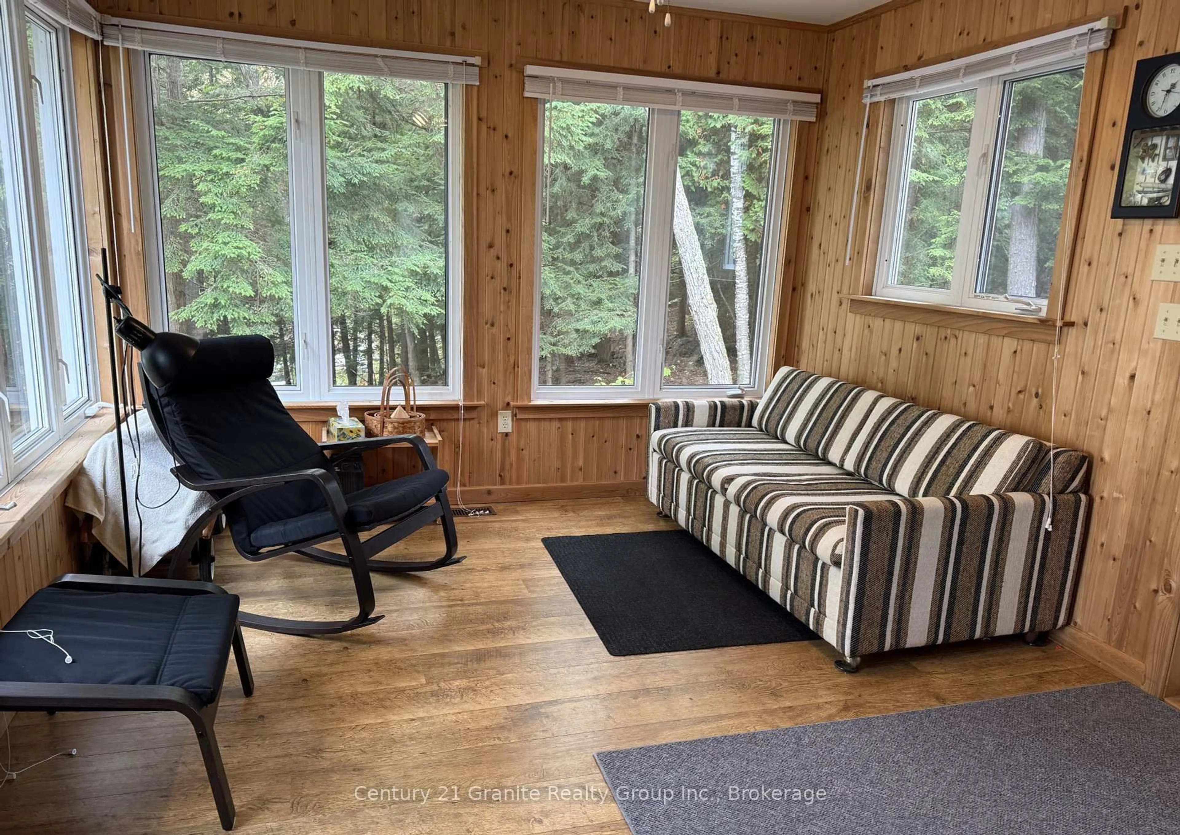 Living room with furniture, wood/laminate floor for 1773 Blue Heron Rd, Dysart et al Ontario K0M 1S0