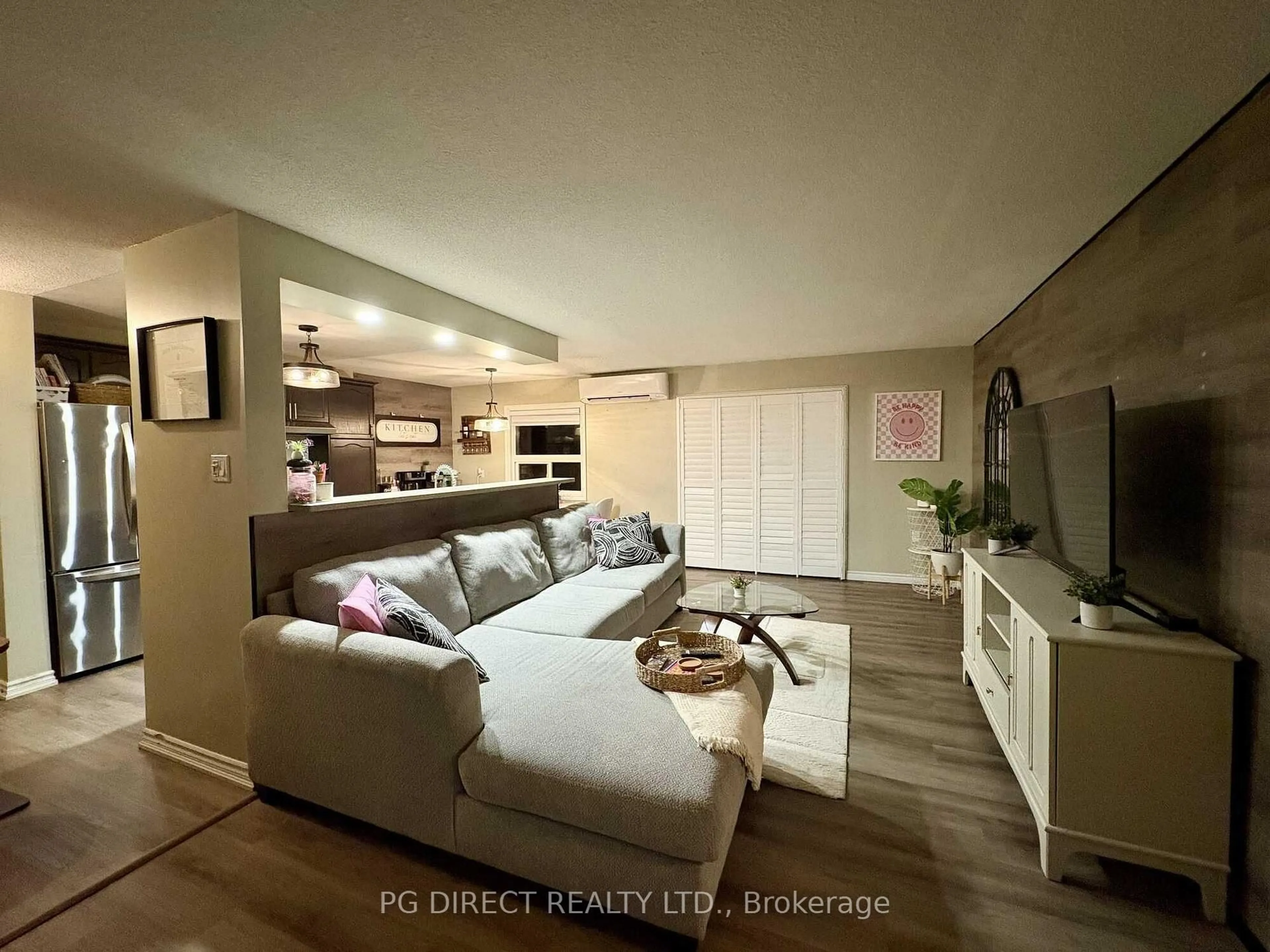 Living room with furniture, wood/laminate floor for 616 Grey St #15, Brantford Ontario N3S 4T3