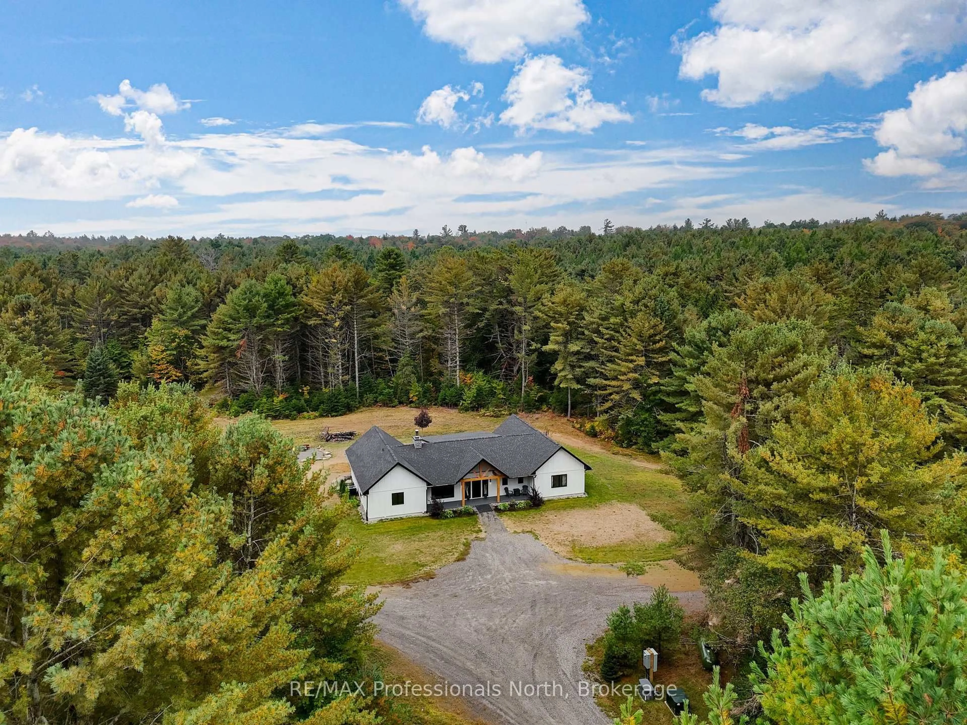 A pic from outside/outdoor area/front of a property/back of a property/a pic from drone, forest/trees view for 1064 Naismith Rd, Bracebridge Ontario P1L 1X4