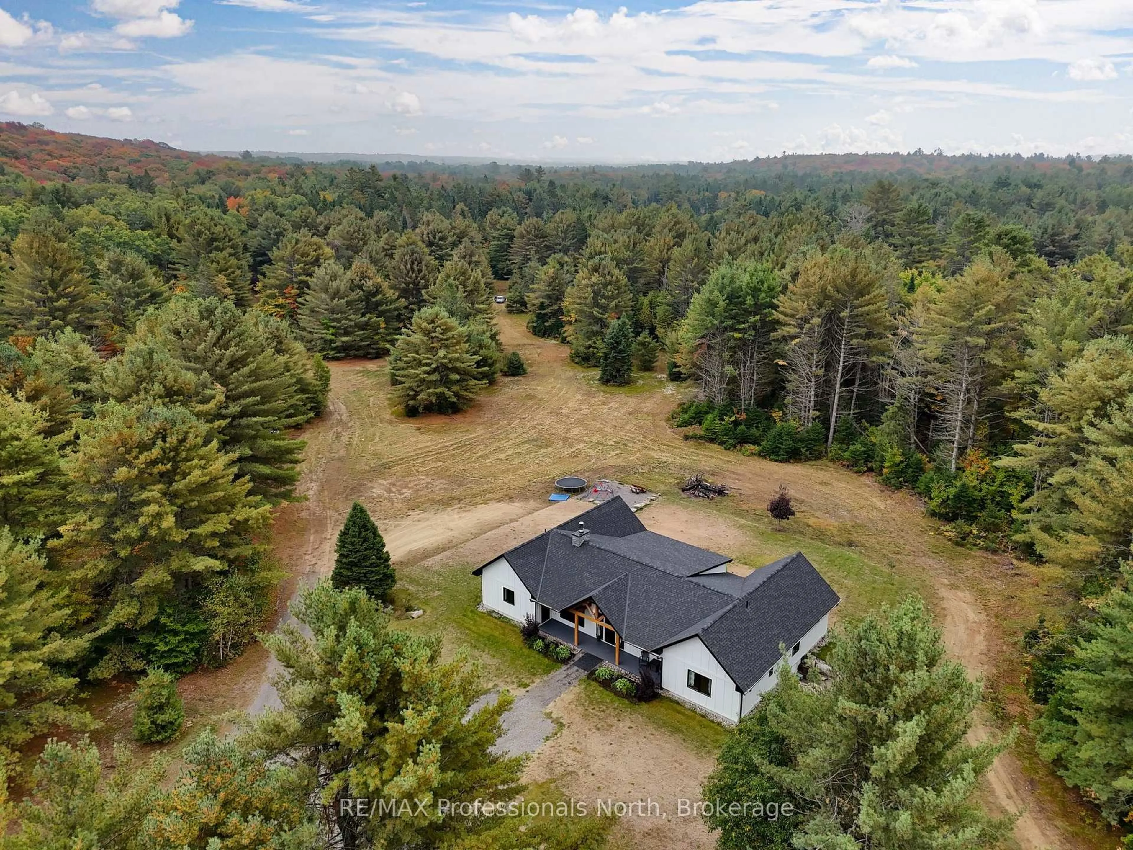 A pic from outside/outdoor area/front of a property/back of a property/a pic from drone, forest/trees view for 1064 Naismith Rd, Bracebridge Ontario P1L 1X4