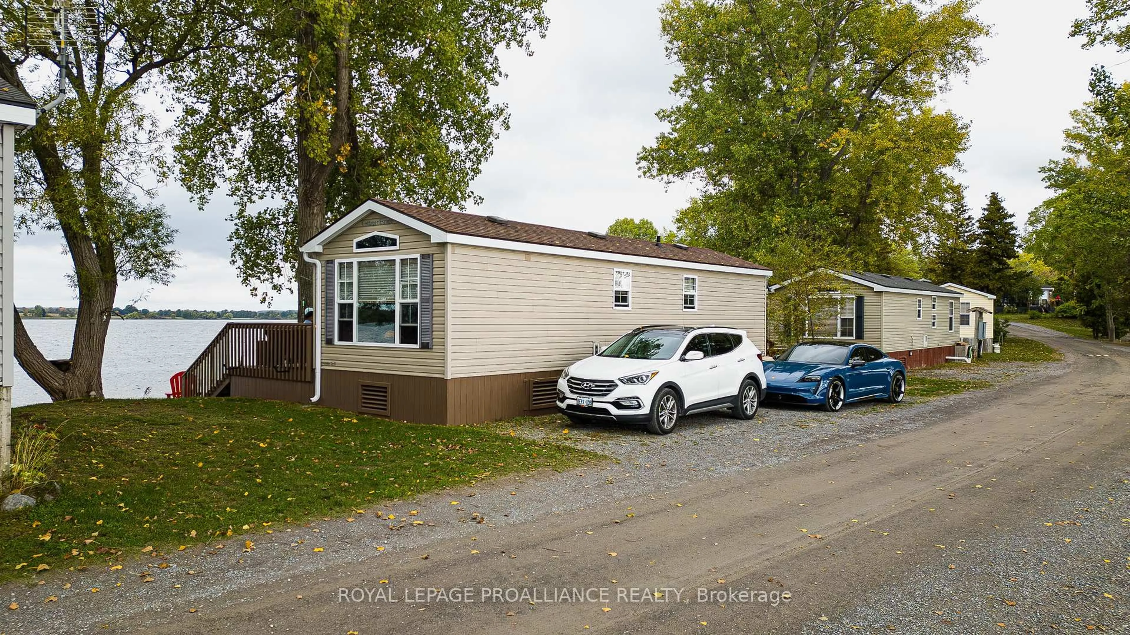 Home with vinyl exterior material, street for 486 Cty Rd 18 64 Cherry Beach Lane, Prince Edward County Ontario K0K 2T0