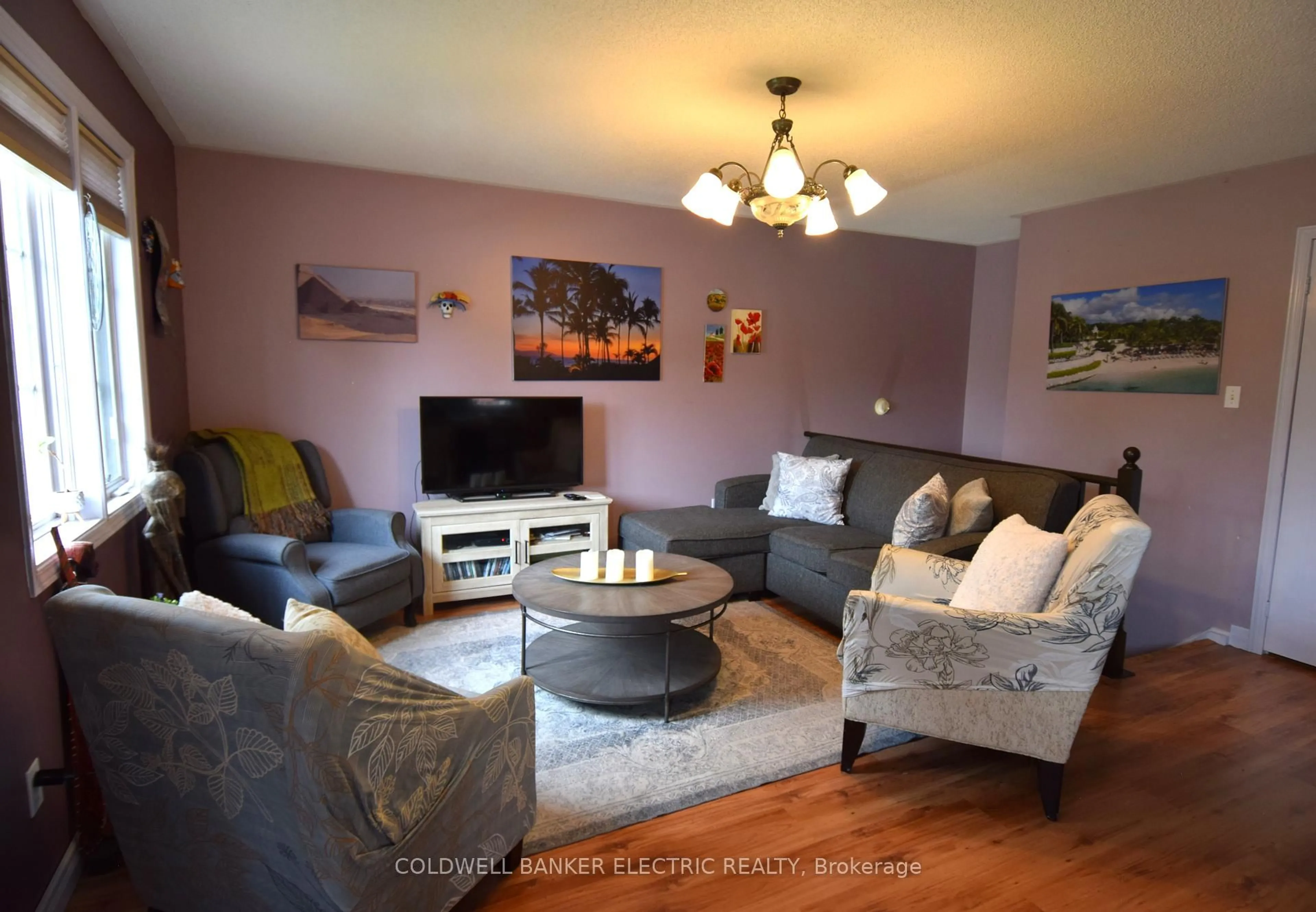 Living room with furniture, wood/laminate floor for 247 Towerhill Rd, Peterborough Ontario K9H 7N1