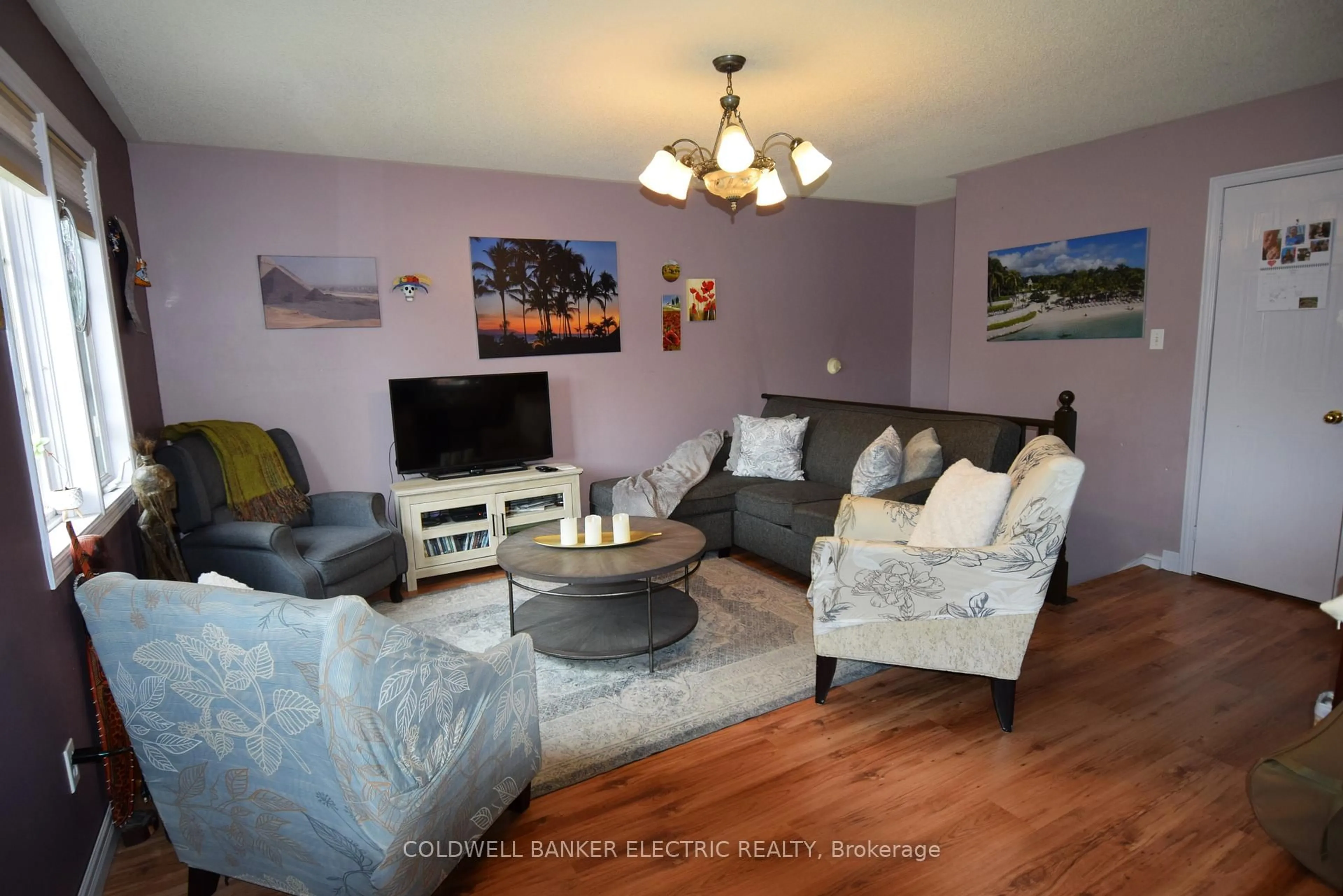 Living room with furniture, wood/laminate floor for 247 Towerhill Rd, Peterborough Ontario K9H 7N1