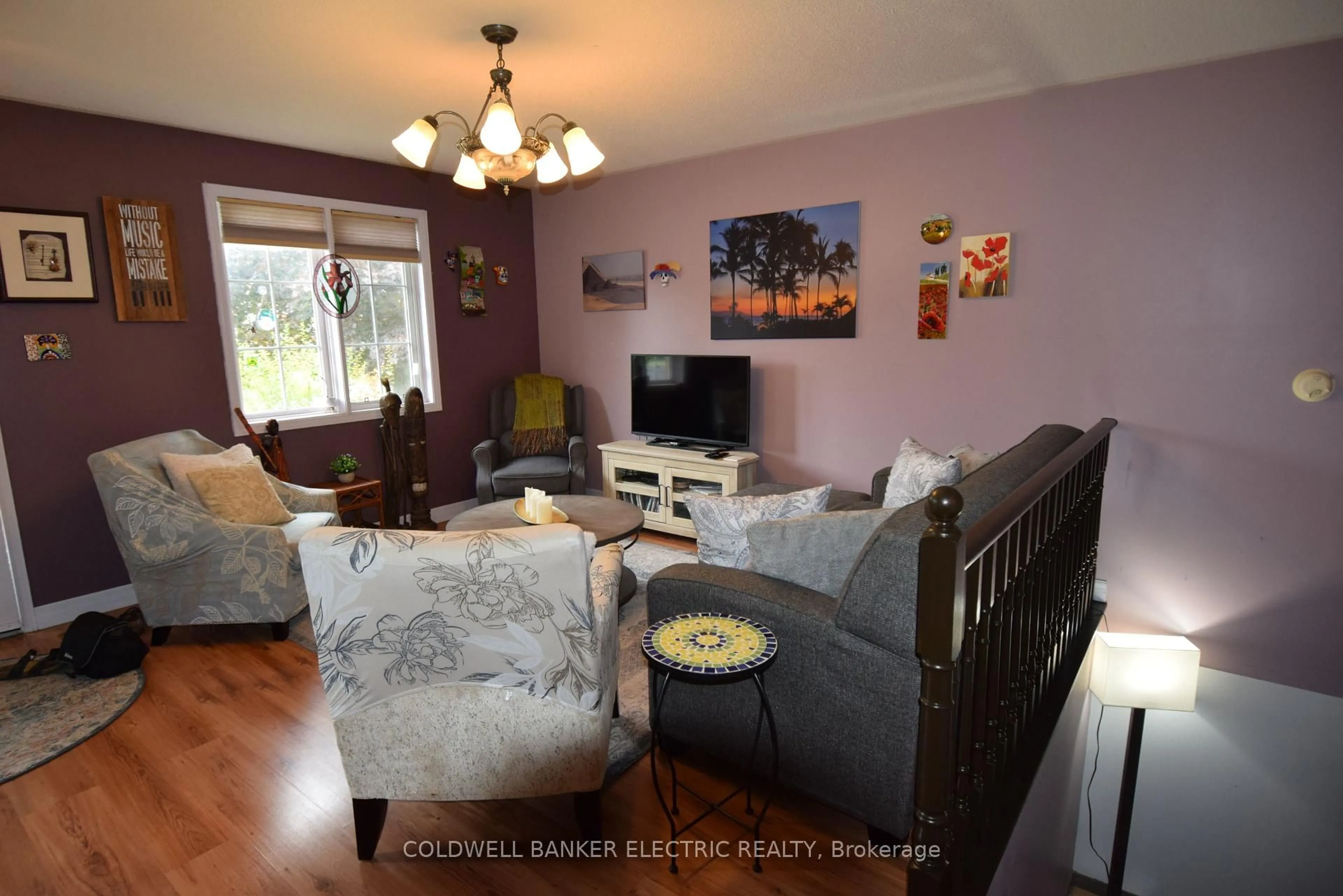 Living room with furniture, wood/laminate floor for 247 Towerhill Rd, Peterborough Ontario K9H 7N1