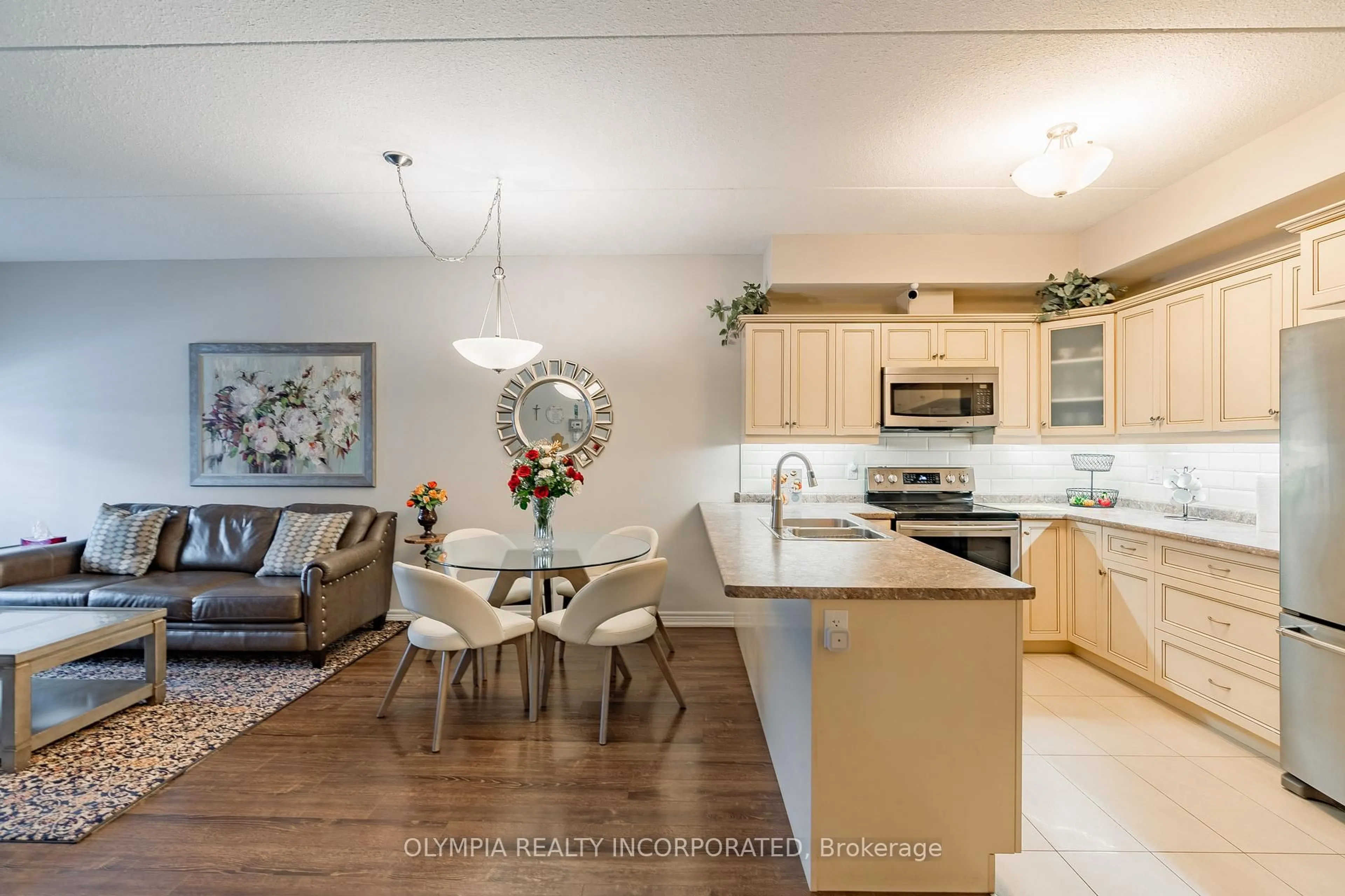 Open concept kitchen, wood/laminate floor for 4464 Pettit Ave #117, Niagara Falls Ontario L2E 0B4