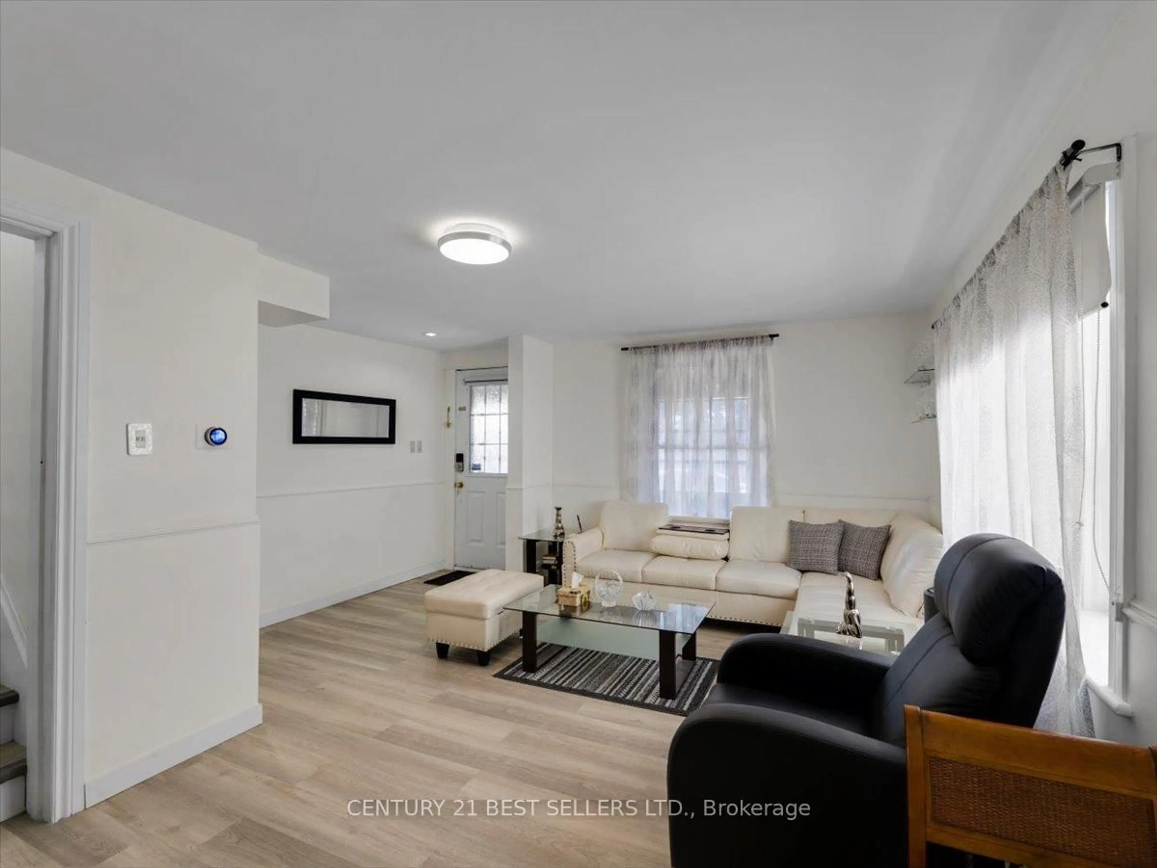 Living room with furniture, wood/laminate floor for 39 Carlton St, St. Catharines Ontario L2R 1P7