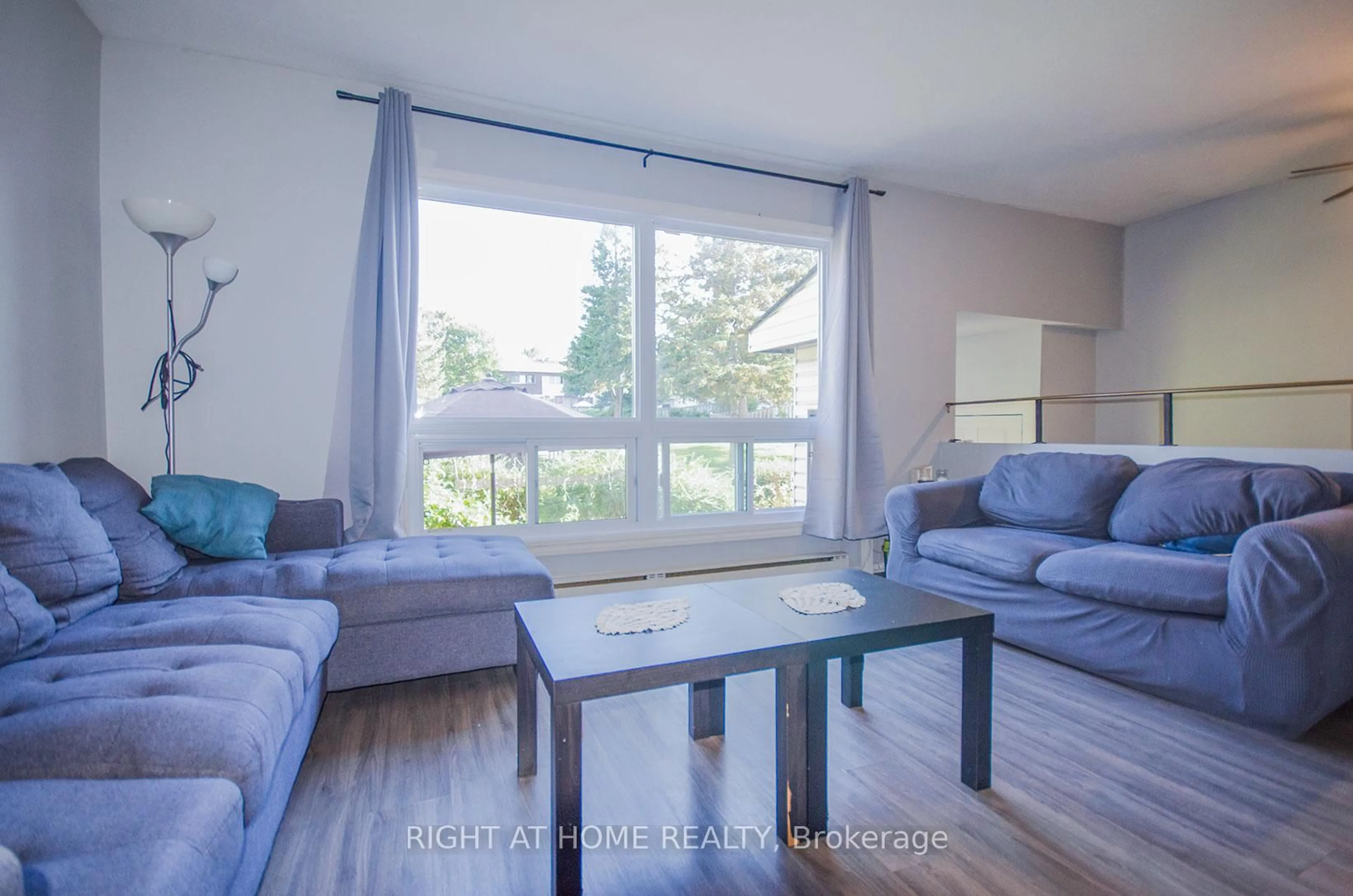 Living room with furniture, wood/laminate floor for 2640 Draper Ave #53, Ottawa Ontario K2H 8V3