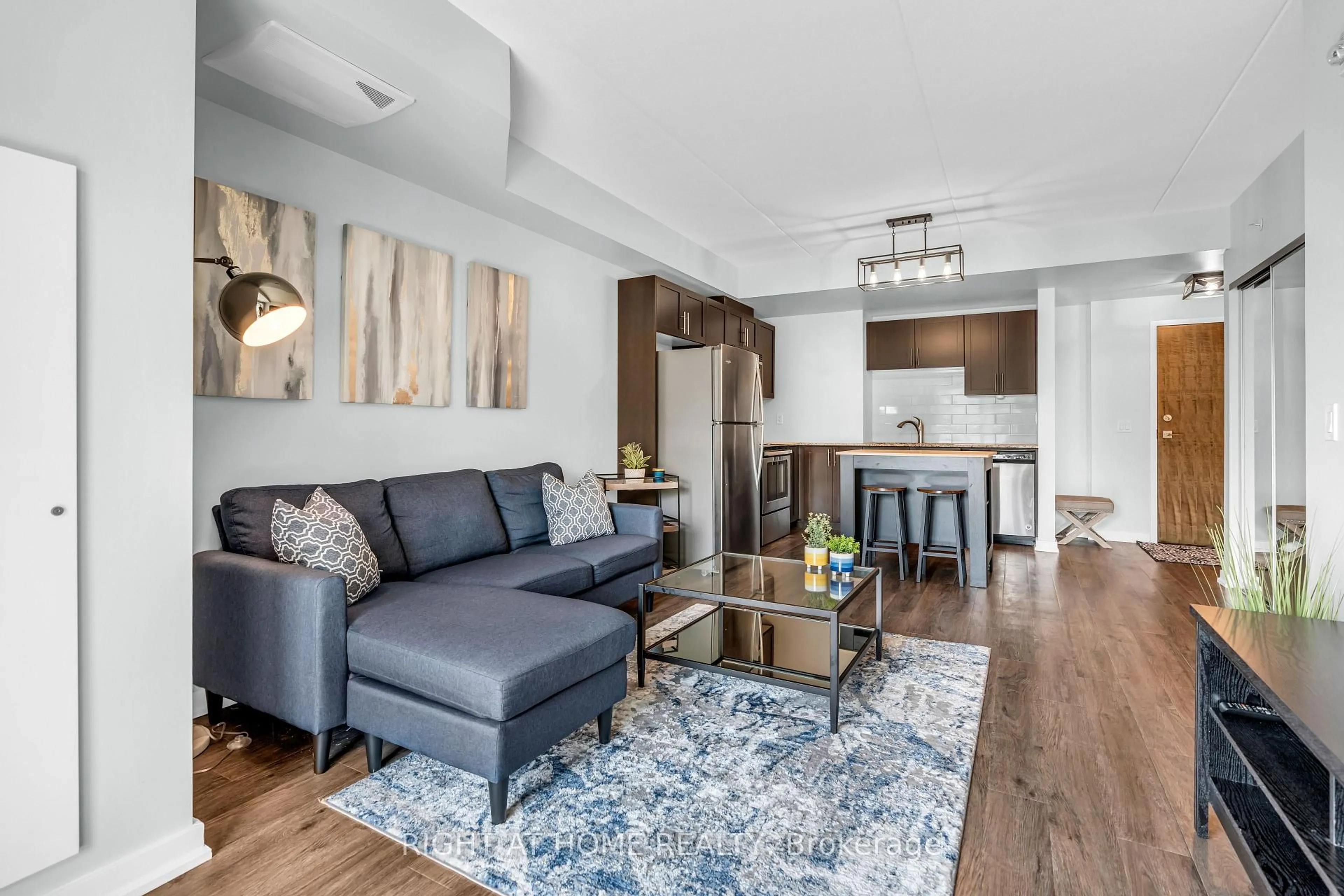 Living room with furniture, wood/laminate floor for 25 Kay Cres #LL12, Guelph Ontario N1L 0P2