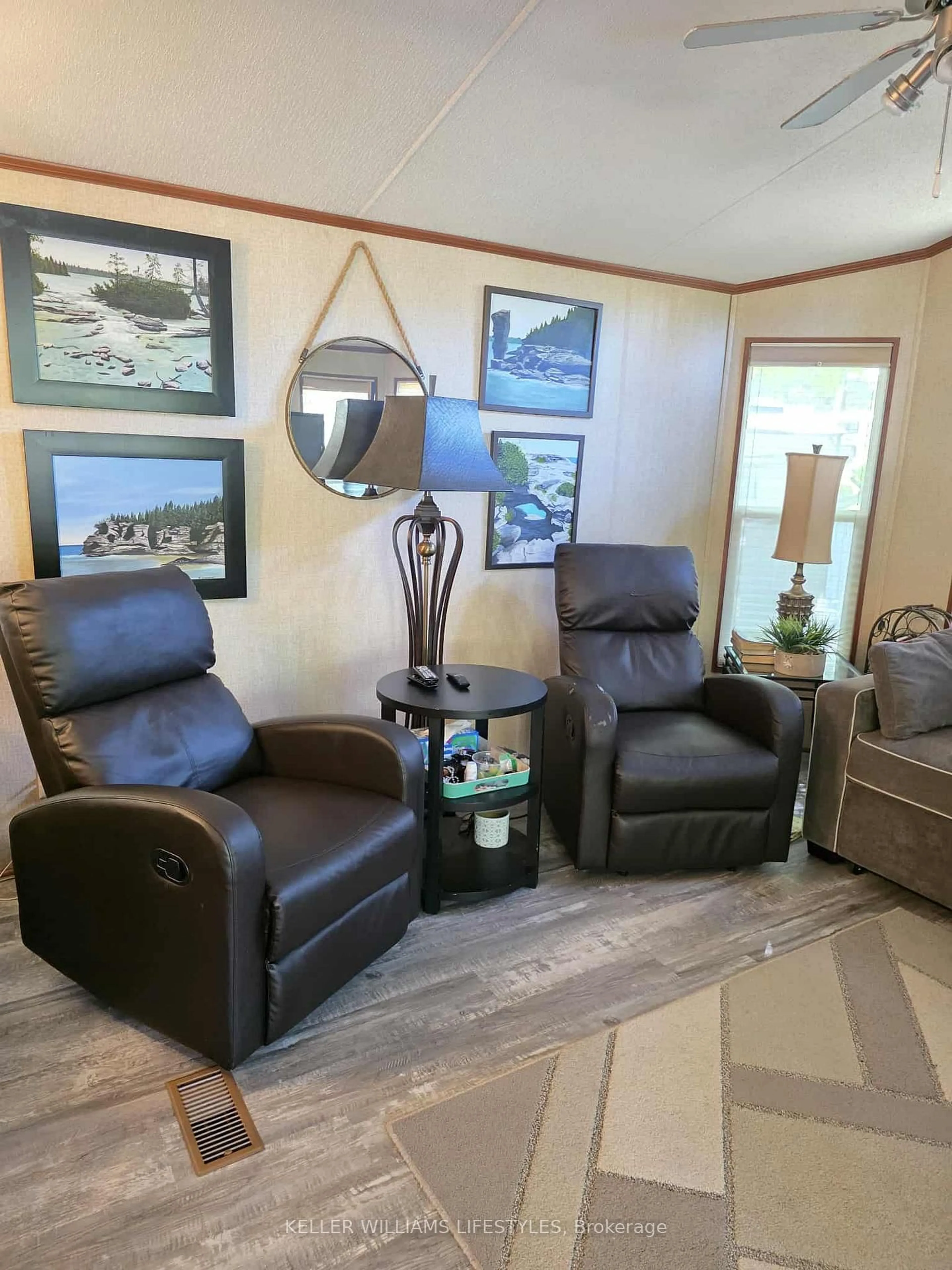 Living room with furniture, wood/laminate floor for 9338 West Ipperwash Rd #JJ24, Lambton Shores Ontario N0N 1J2