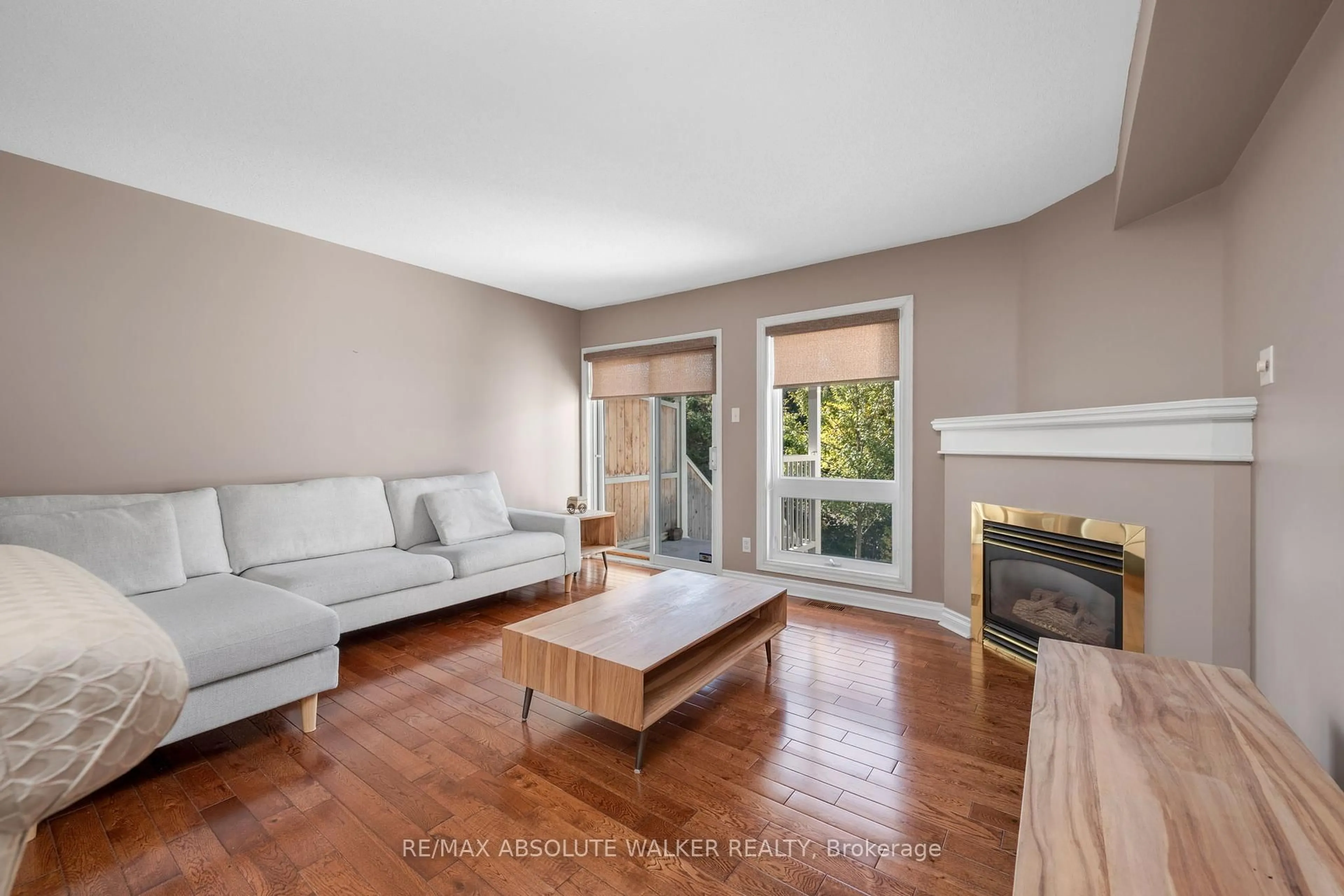 Living room with furniture, wood/laminate floor for 1647 Locksley Lane, Ottawa Ontario K1J 1B6