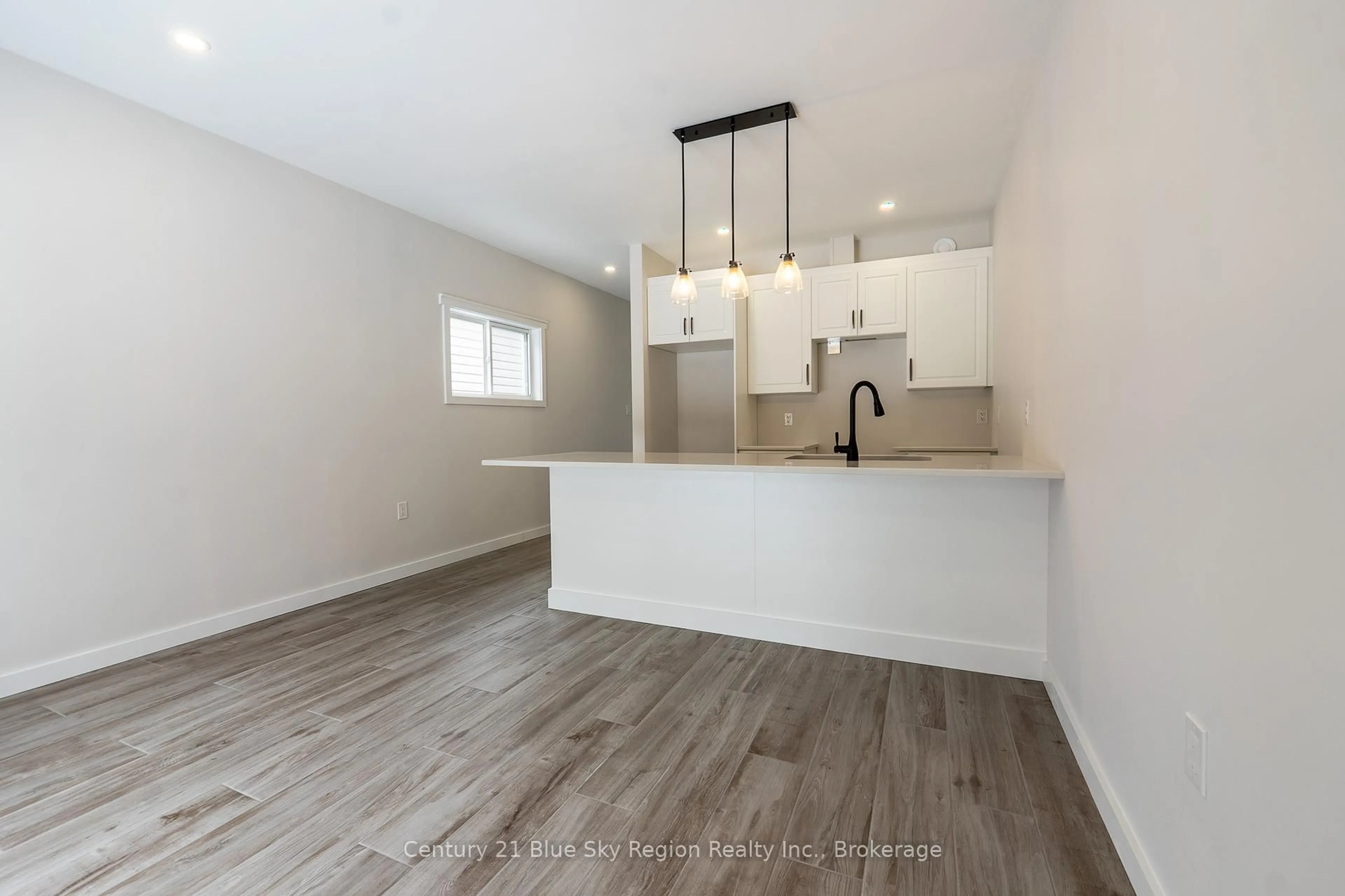 Open concept kitchen, wood/laminate floor for 16 Birch St, Powassan Ontario P0H 1Z0