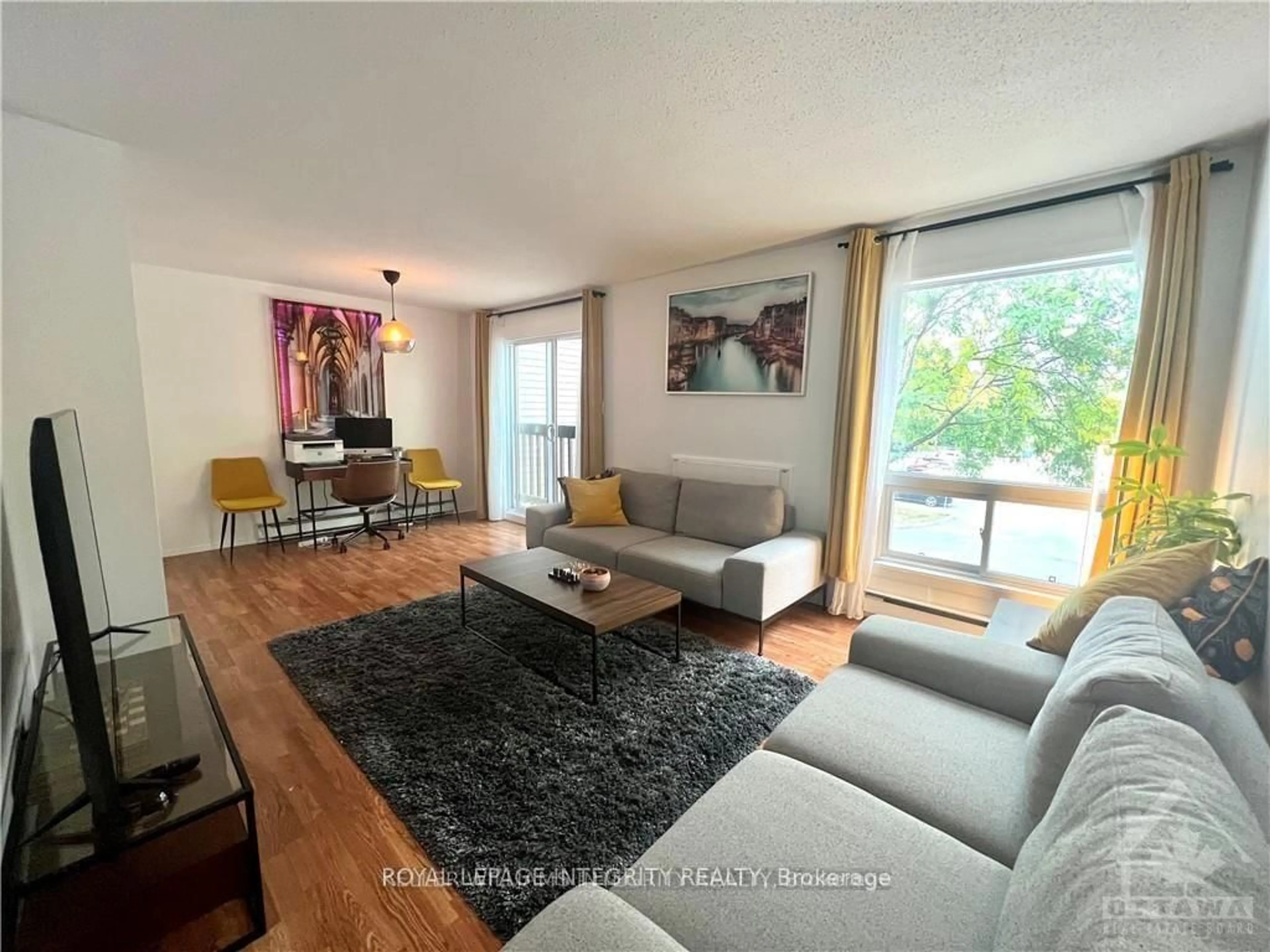 Living room with furniture, wood/laminate floor for 240 FENERTY Crt #8, Ottawa Ontario K2L 3A7