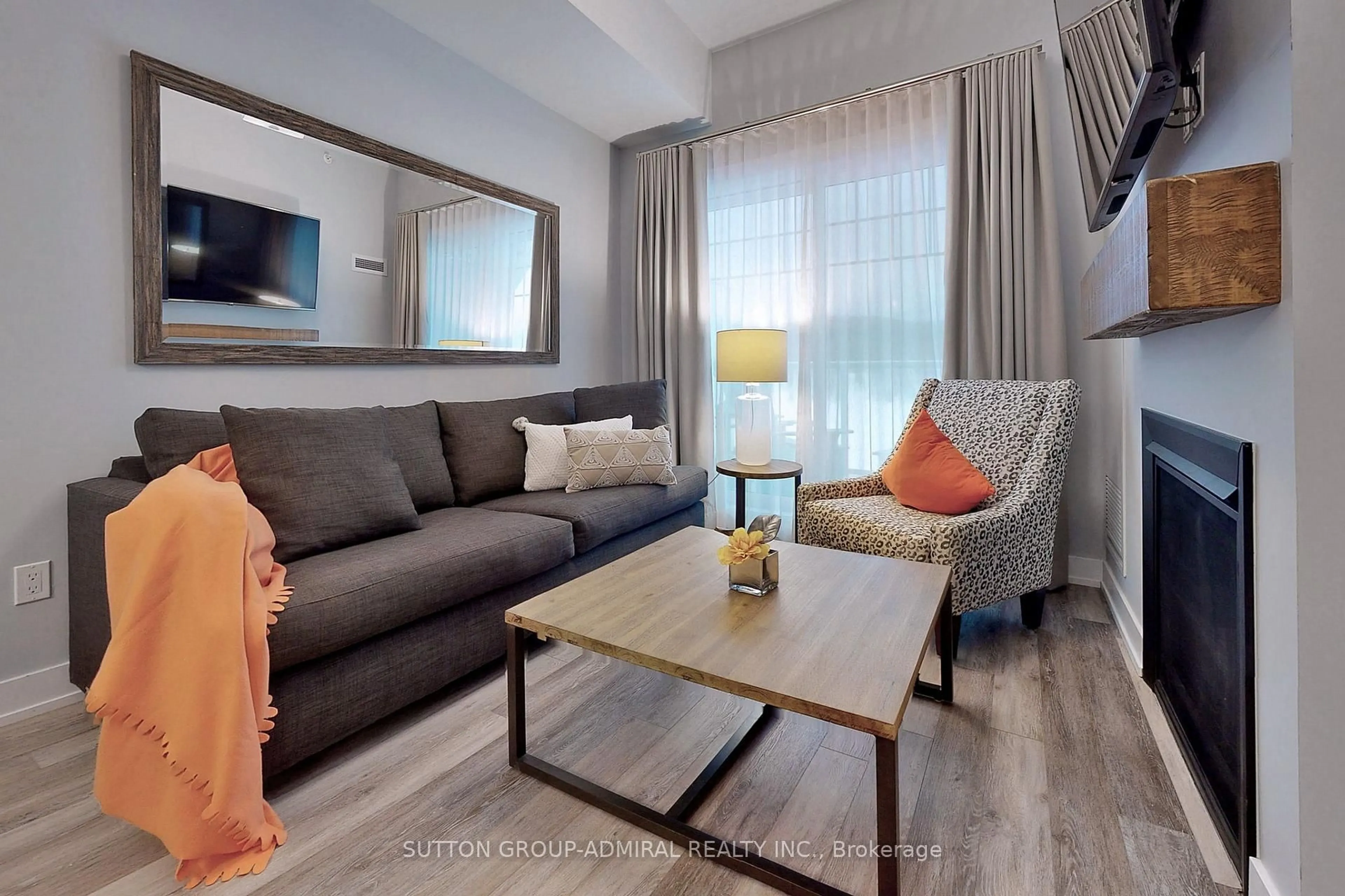 Living room with furniture, wood/laminate floor for 25 Pen Lake Point Rd #425, Huntsville Ontario P1H 1A9