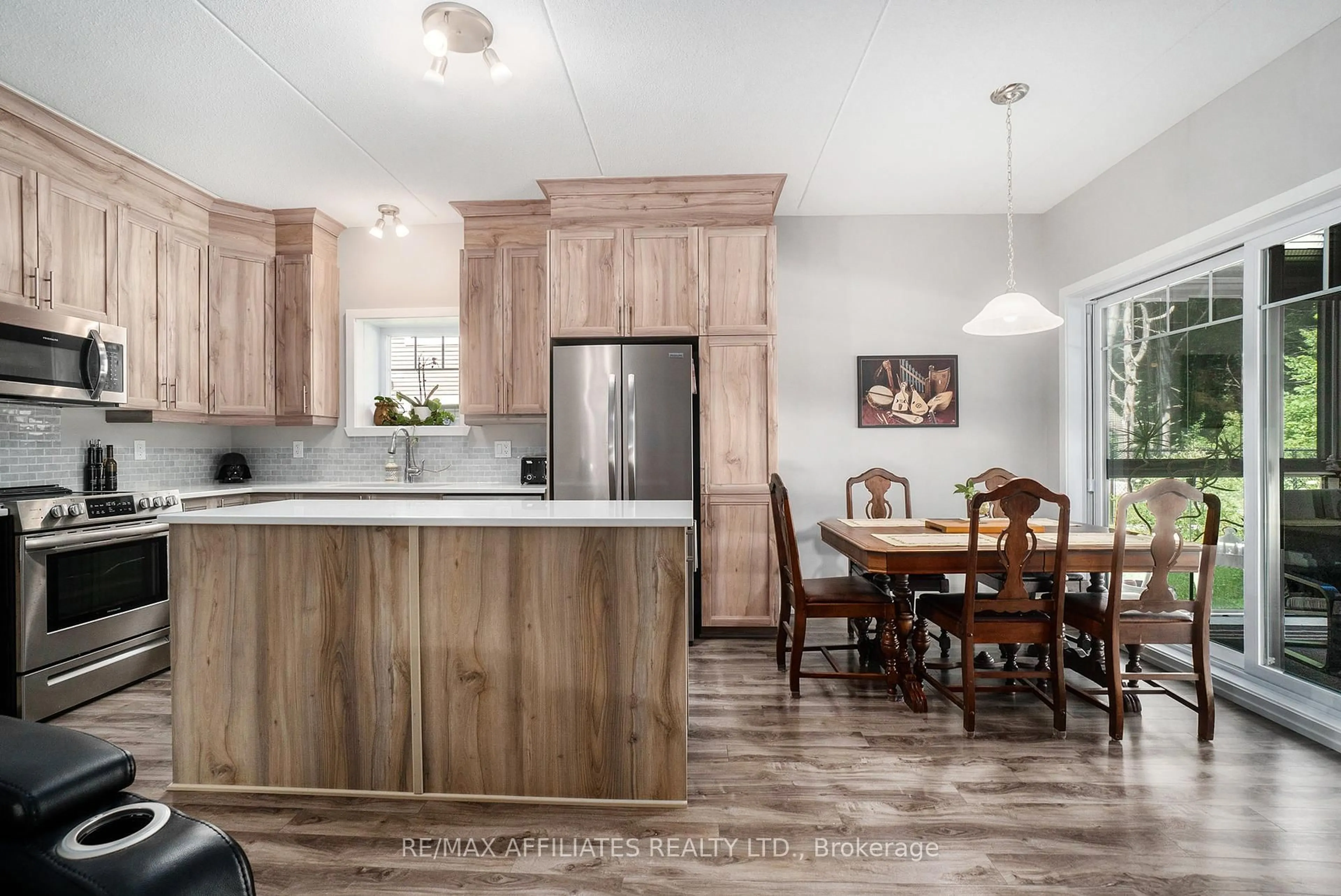 Open concept kitchen, wood/laminate floor for 99 St-Moritz Tr #401, Russell Ontario K0A 1W0