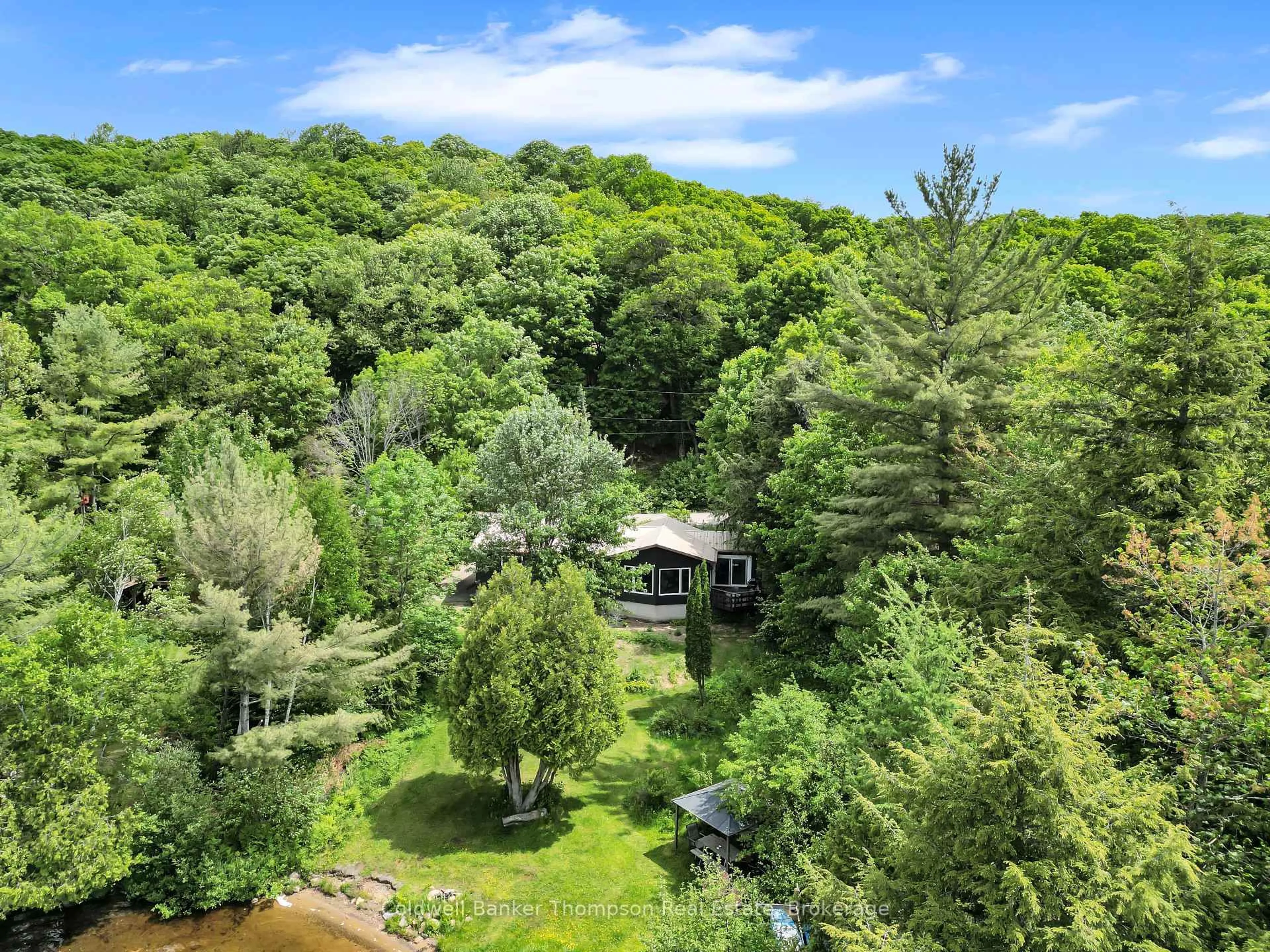 A pic from outside/outdoor area/front of a property/back of a property/a pic from drone, forest/trees view for 810 East Waseosa Lake Rd, Huntsville Ontario P1H 2J4