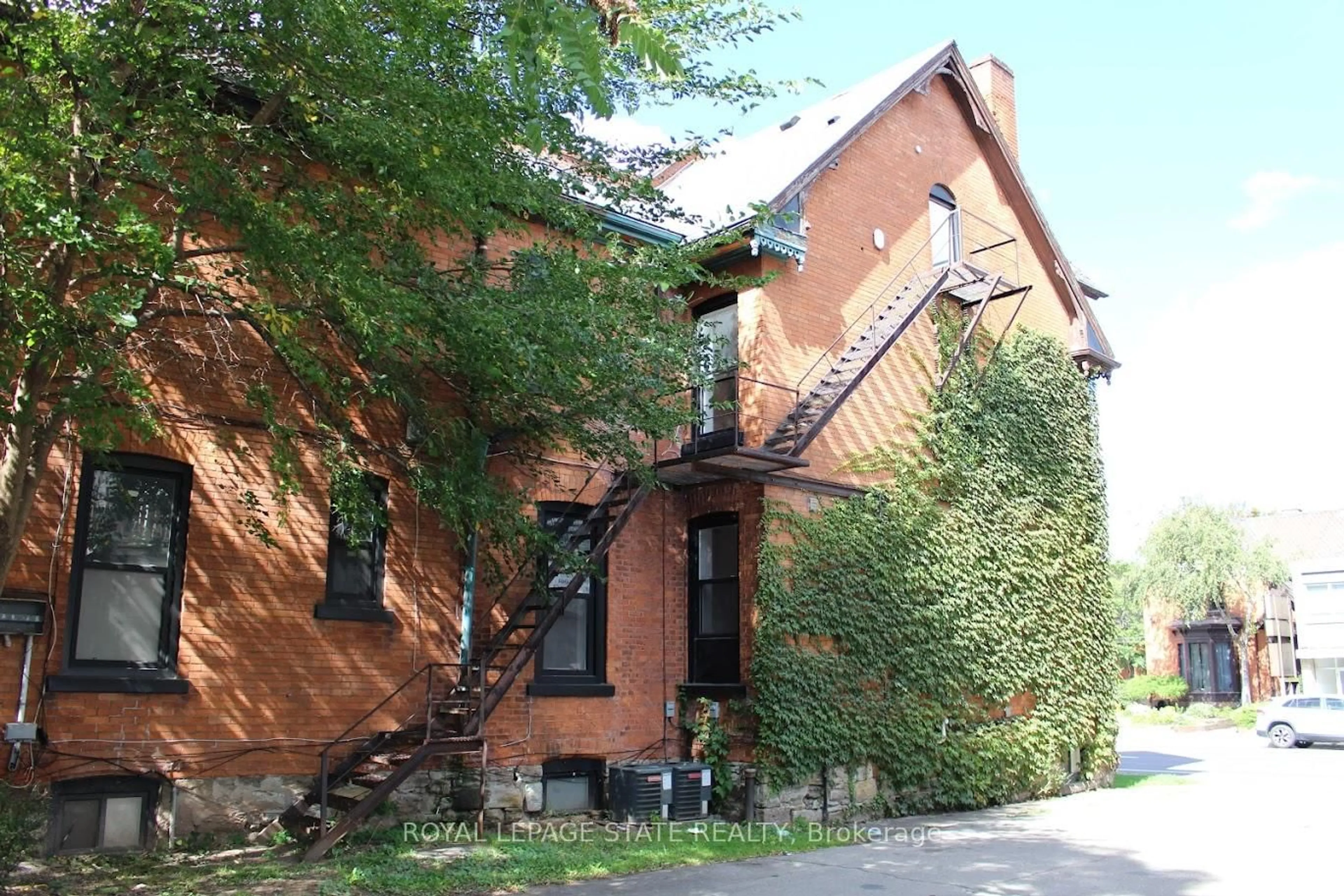 Home with brick exterior material, street for 500 Main St #E, Hamilton Ontario L8N 1K7