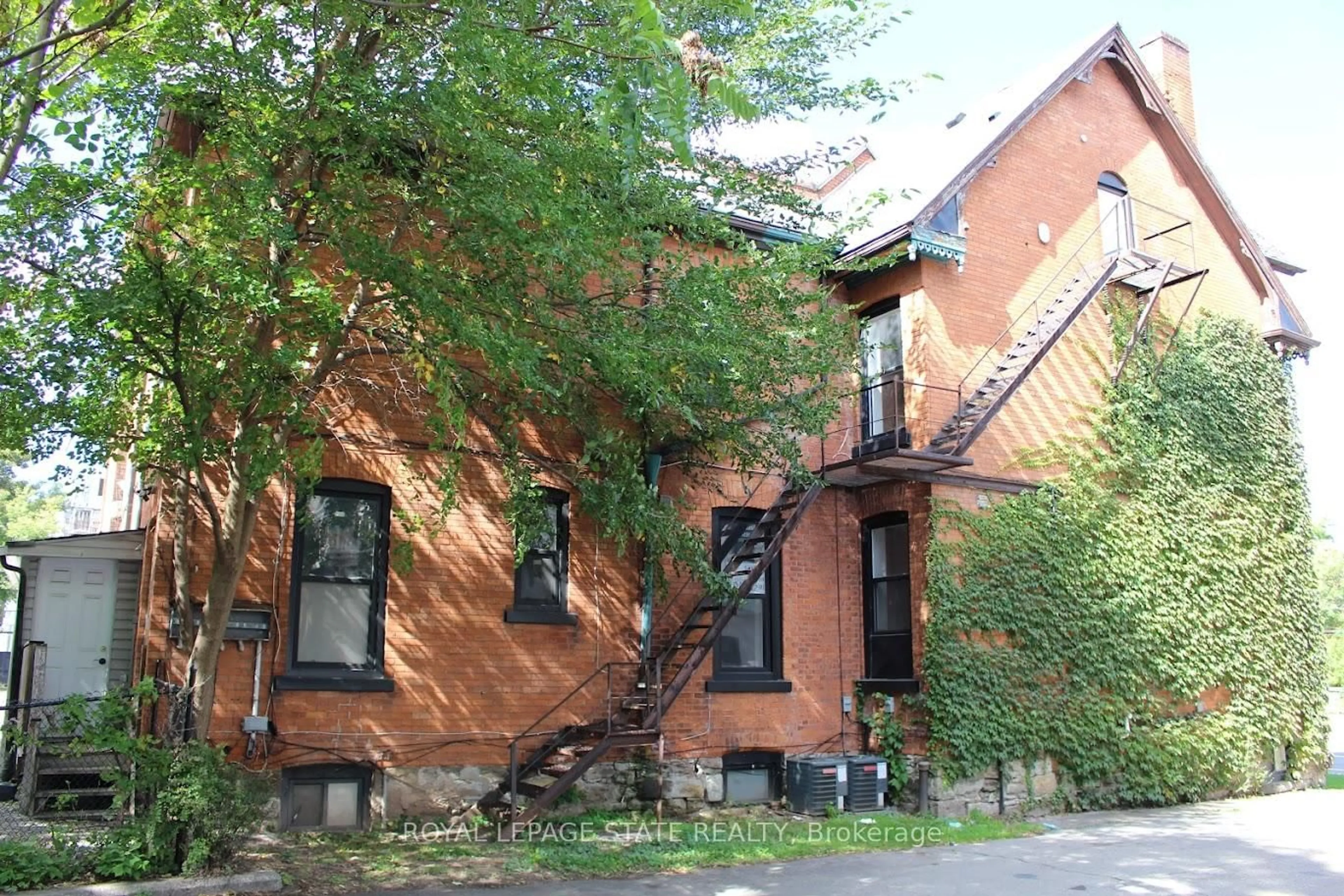 Home with brick exterior material, street for 500 Main St #E, Hamilton Ontario L8N 1K7