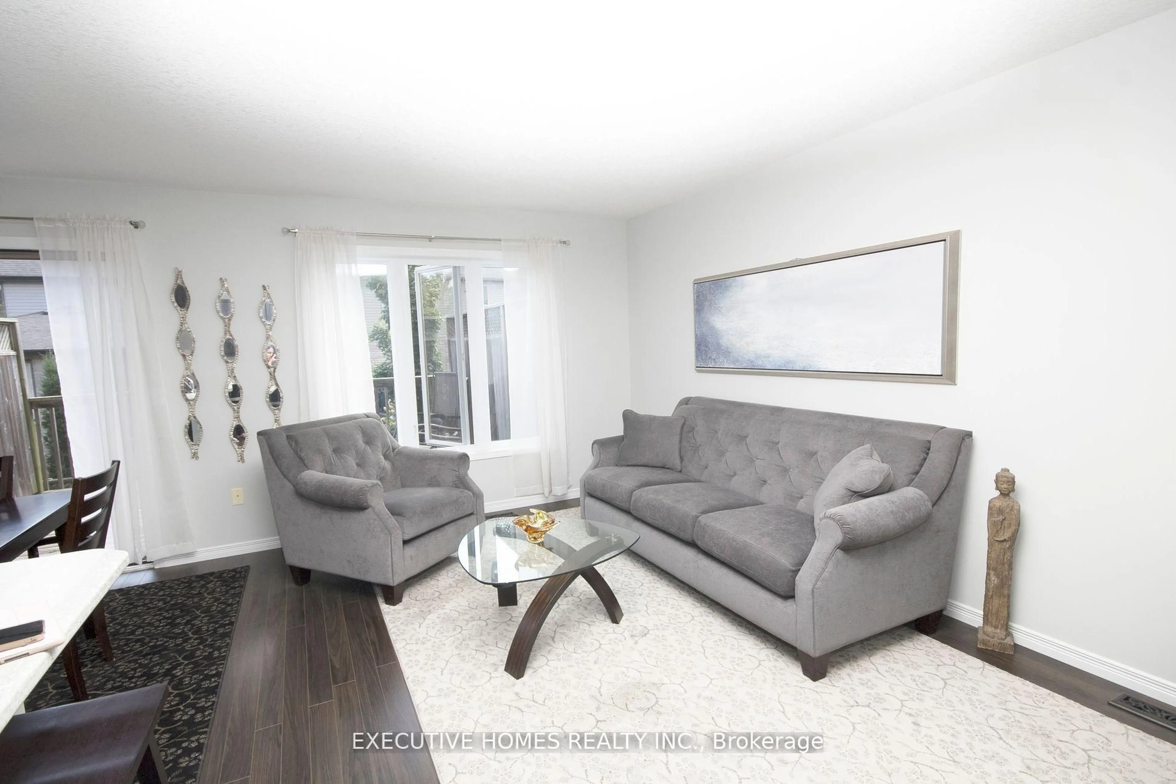 Living room with furniture, wood/laminate floor for 2635 Bateman Tr #129, London South Ontario N6L 0B1