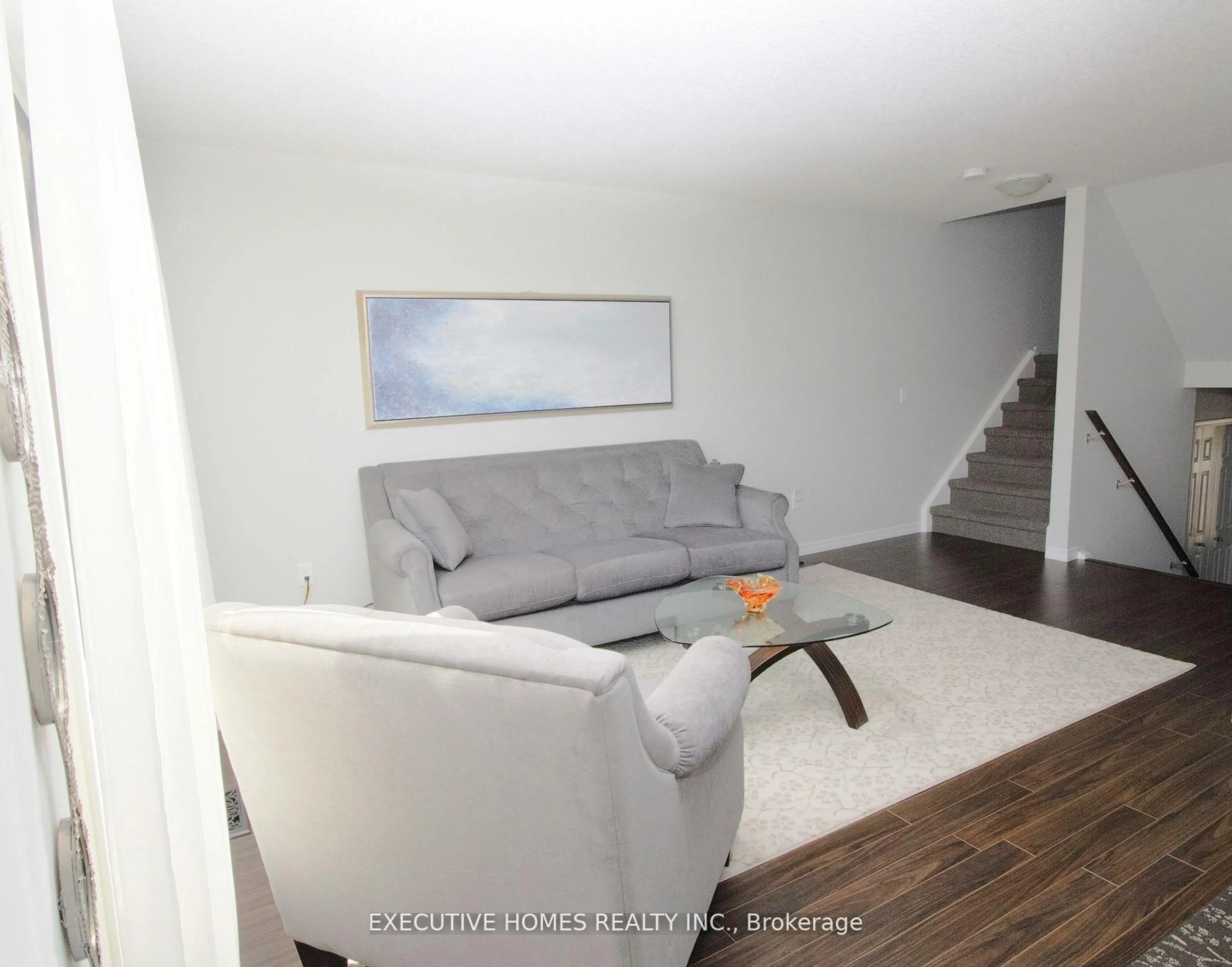 Living room with furniture, wood/laminate floor for 2635 Bateman Tr #129, London South Ontario N6L 0B1