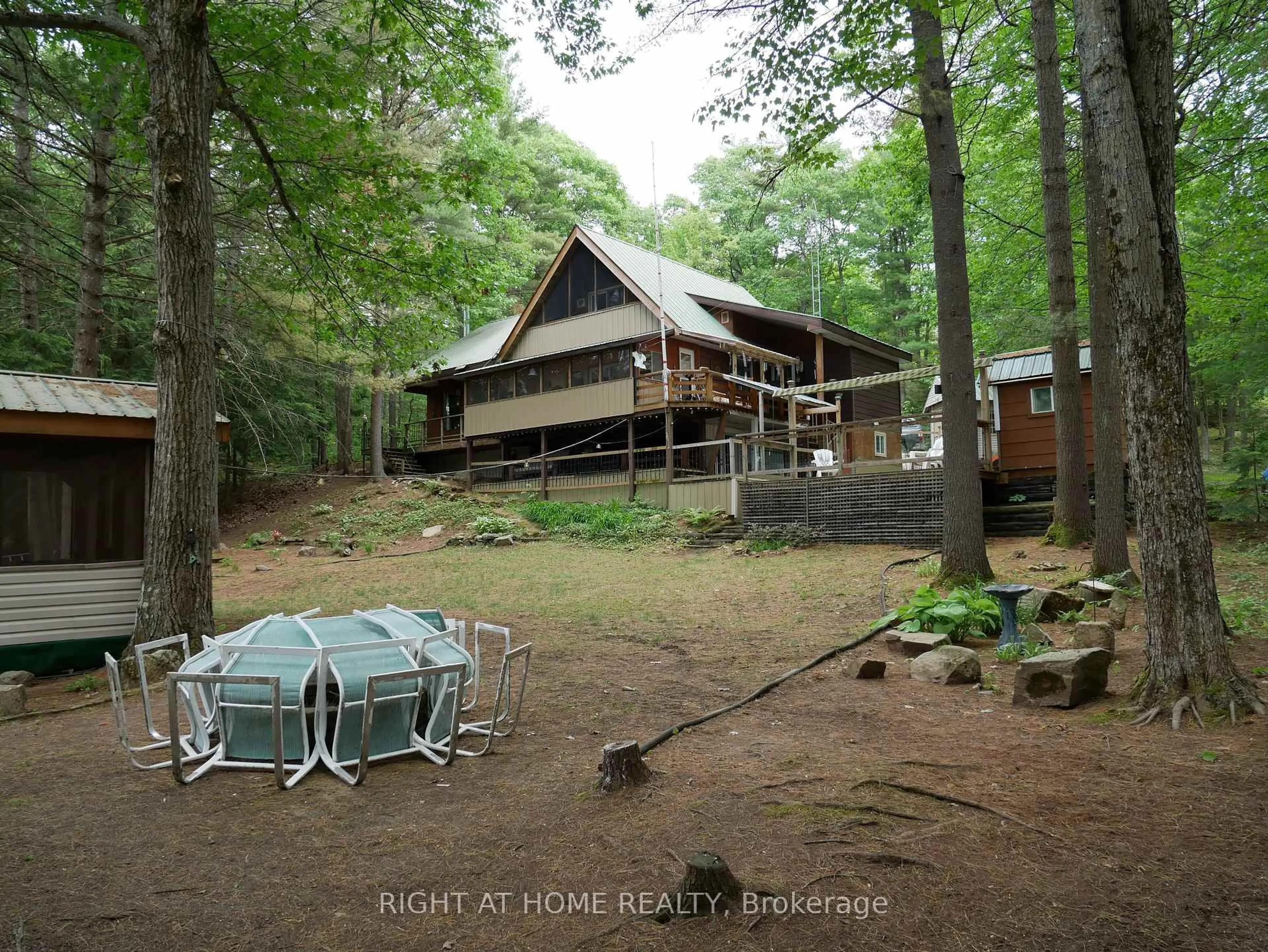 A pic from outside/outdoor area/front of a property/back of a property/a pic from drone, forest/trees view for 1130 Towering Oaks Tr, Minden Hills Ontario K0M 2L1