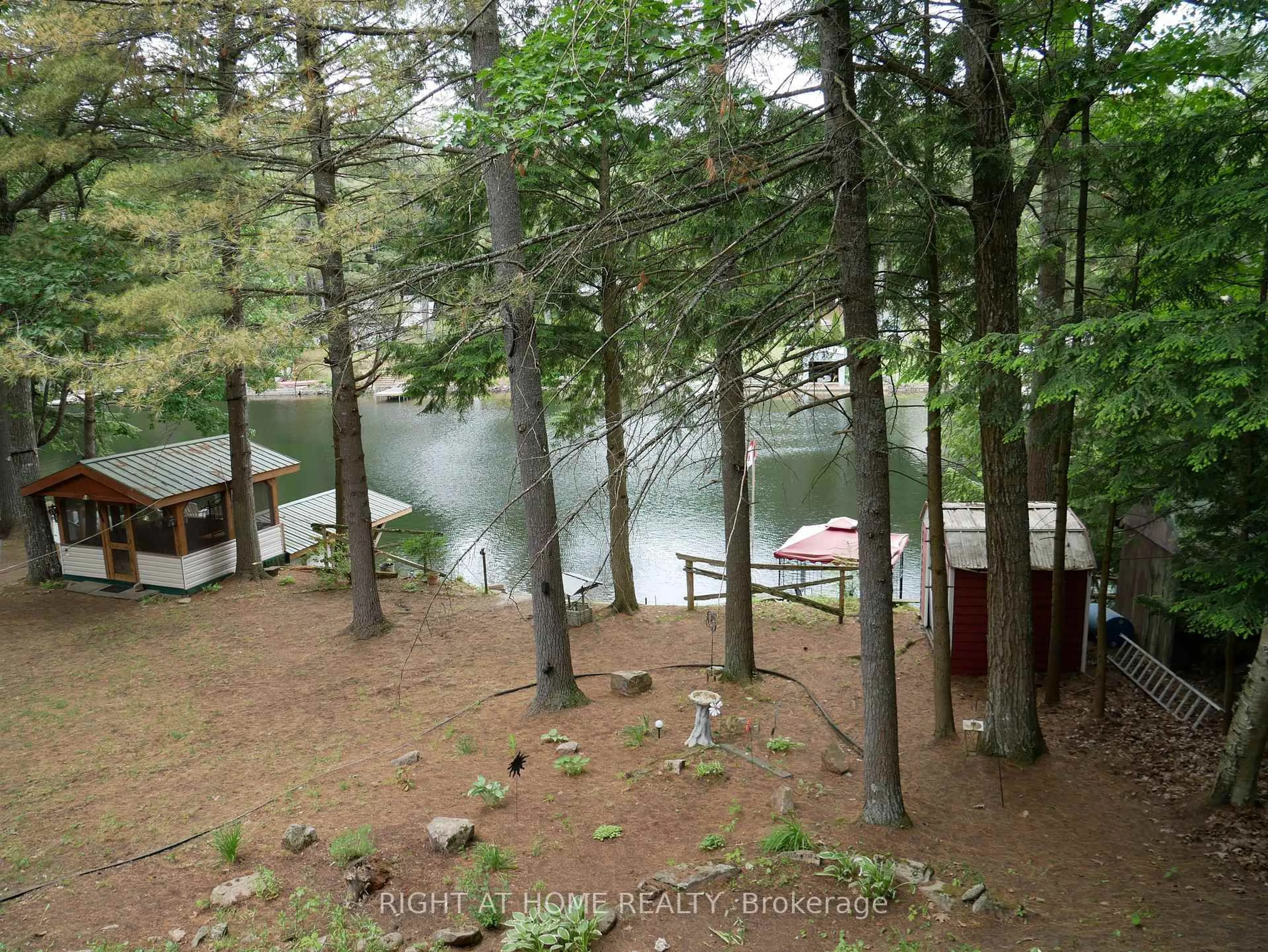 A pic from outside/outdoor area/front of a property/back of a property/a pic from drone, water/lake/river/ocean view for 1130 Towering Oaks Tr, Minden Hills Ontario K0M 2L1