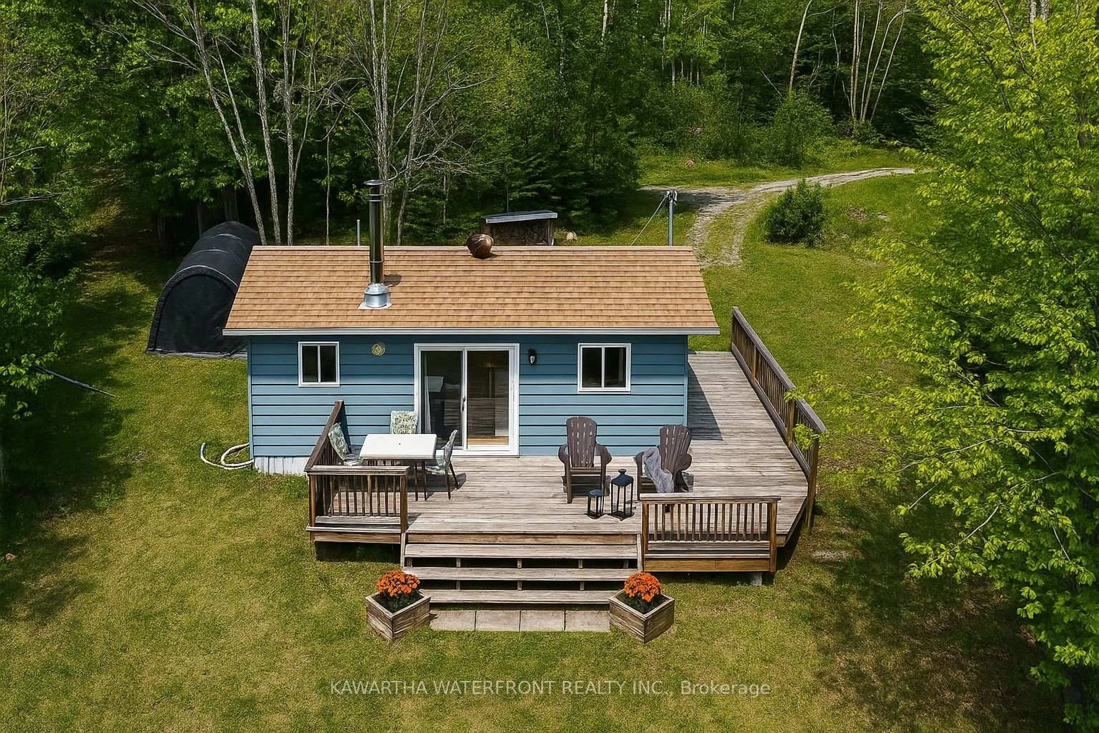 A pic from outside/outdoor area/front of a property/back of a property/a pic from drone, water/lake/river/ocean view for 1120 English Circ, Highlands East Ontario K0M 1R0
