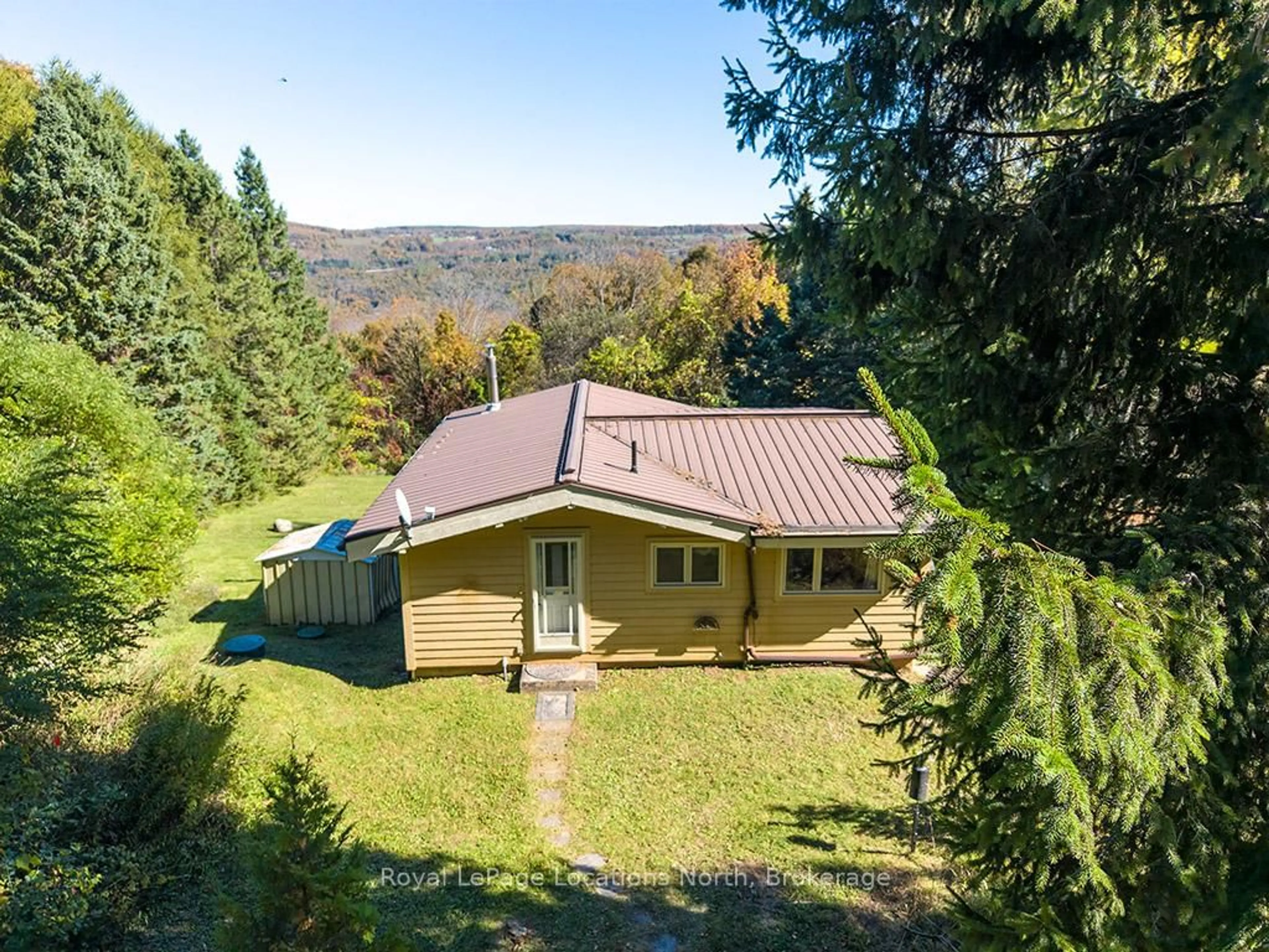 A pic from outside/outdoor area/front of a property/back of a property/a pic from drone, forest/trees view for 231 Windy Lane Dr, Grey Highlands Ontario N1A 2W1