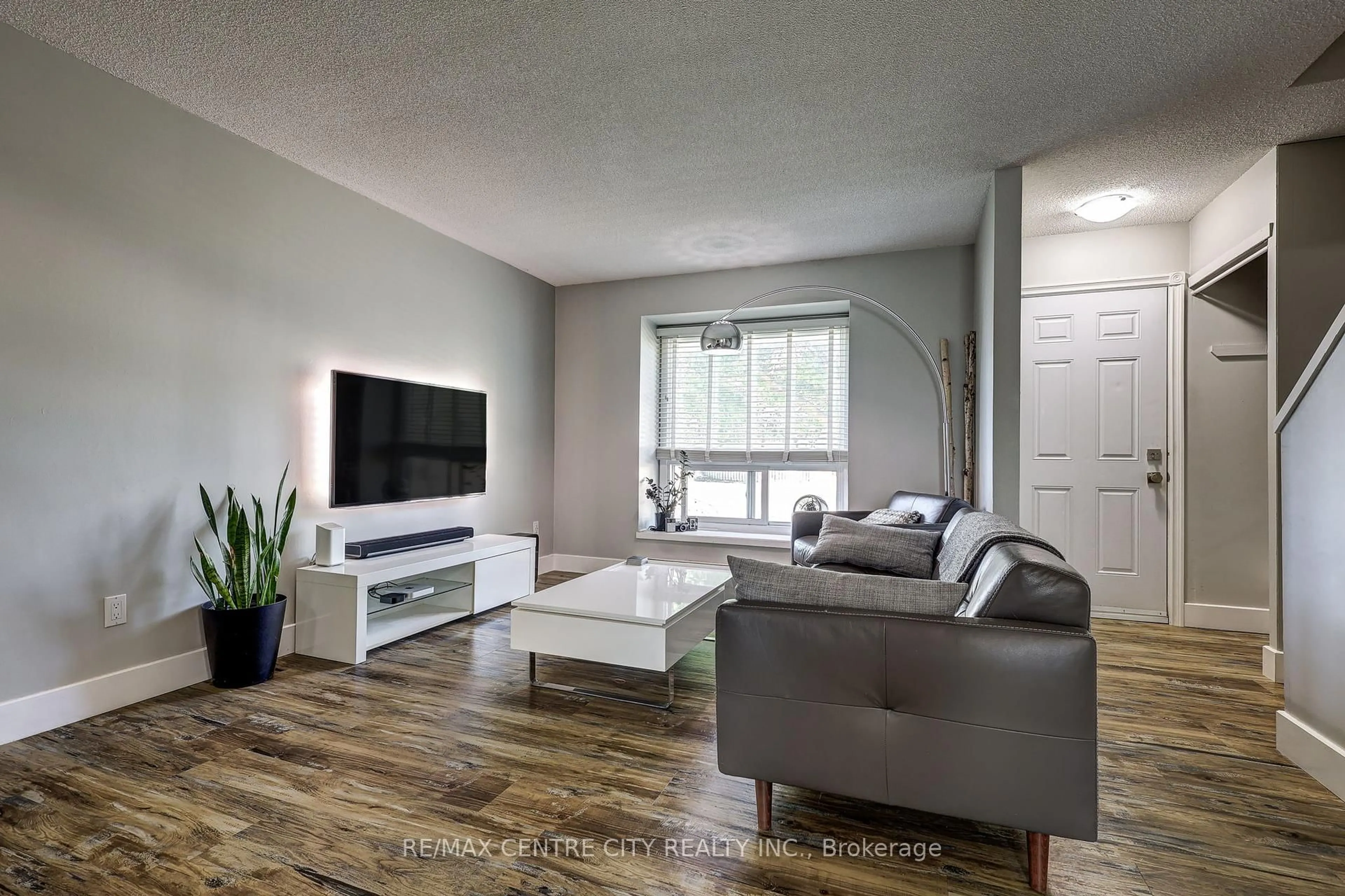 Living room with furniture, wood/laminate floor for 1443 Huron St #5, London East Ontario N5V 2E6