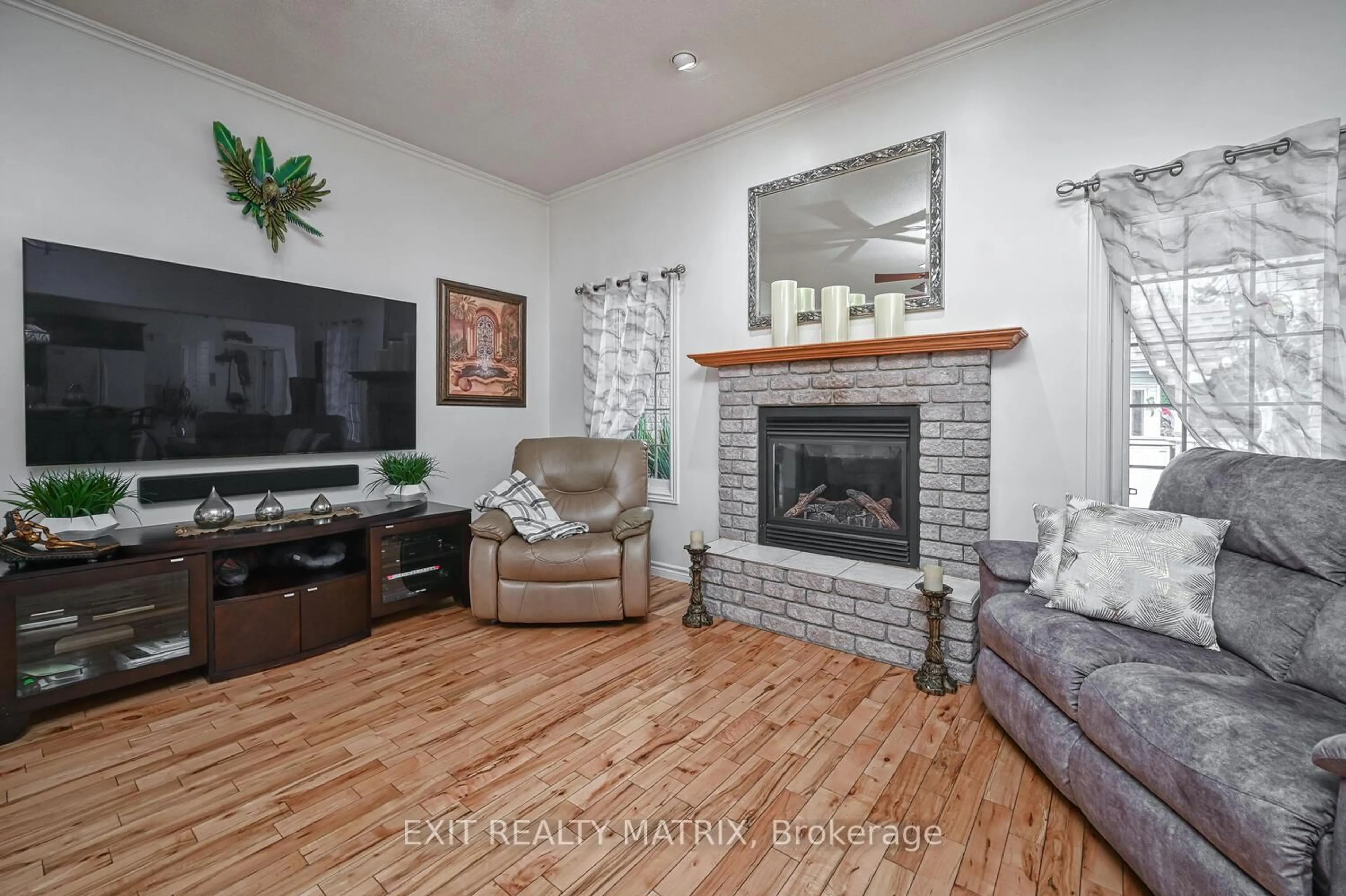 Living room with furniture, wood/laminate floor for 2573 Mitchell St, Metcalfe Ontario K0A 2P0