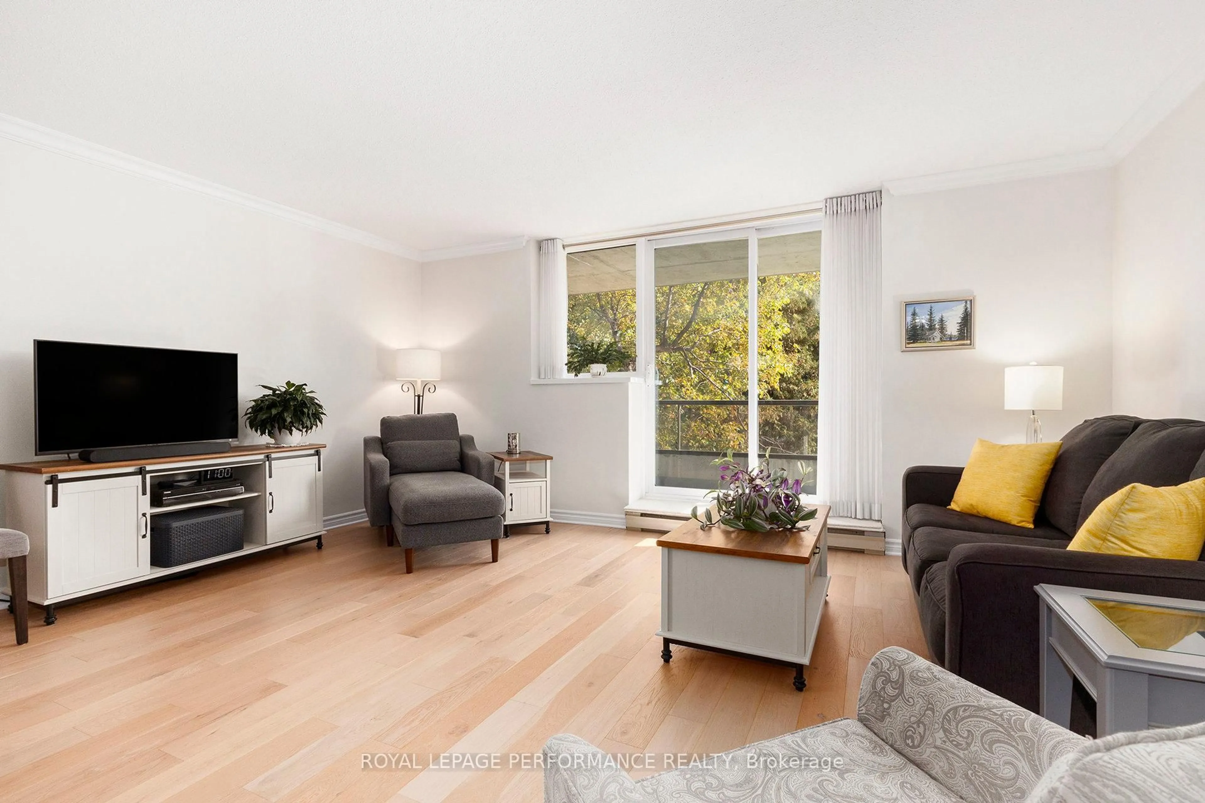 Living room with furniture, wood/laminate floor for 1705 Playfair Dr #101, Ottawa Ontario K1H 8P6